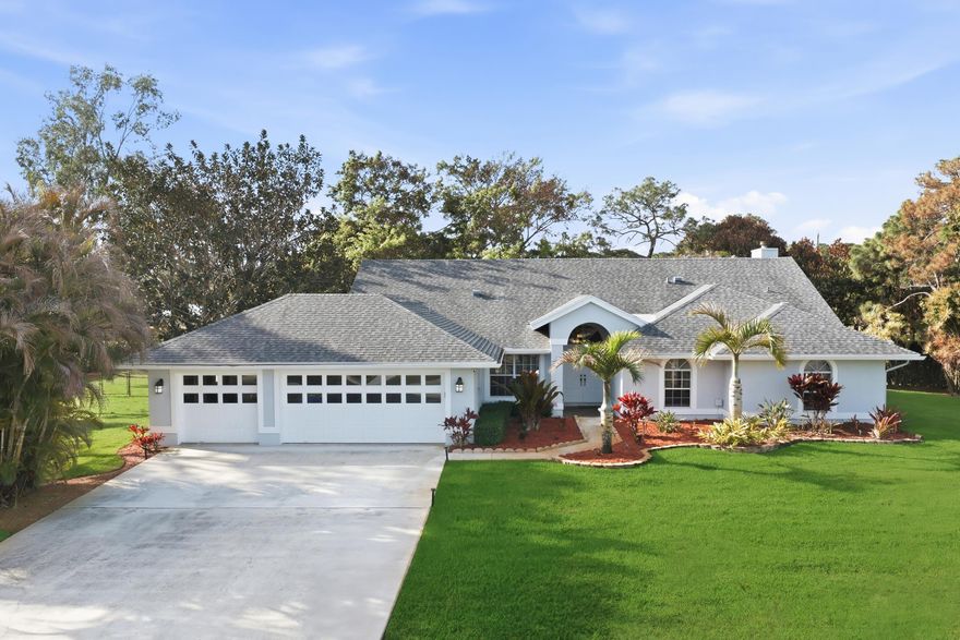 Beautifully maintained CBS home on a full 1-acre corner lot offering privacy, space, and upgrades throughout in the highly desirable Palm Beach Country Estates community. This 4-bedroom, 2.5-bath residence features Italian ceramic tile flooring, fresh interior/exterior paint, a brand-new roof (2025), new water heater (2025), and A/C replaced in 2021 for added peace of mind. The spacious layout includes a 3-car garage, central vacuum system, and plenty of room for vehicles and storage with a dedicated RV driveway.  Enjoy the convenience of a paved road and the charm of the outdoors with mature fruit trees and beautifully landscaped grounds that create a peaceful setting. With ample space for entertaining, gardening, or simply enjoying the land, this property offers the ideal blend of  comfort and functionality.  Located in Palm Beach Country Estates, a sought-after community known for its 1+ acre homesites, privacy, and freedom with no HOA, residents enjoy room for boats, RVs, and outdoor toys while being just minutes from Abacoa, Alton, Jupiter beaches, I-95, and top dining and shopping. This is a rare opportunity to enjoy country-style living with city convenience.