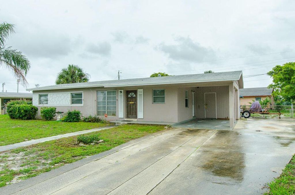 Photo of 724 Date Palm Drive, Lake Park, FL 33403 (MLS # R10711985)