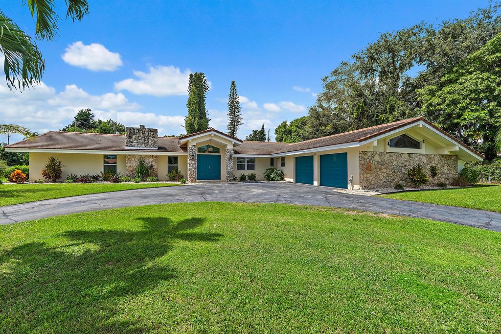 Photo of 437 N Country Club Drive, Atlantis, FL 33462 (MLS # R11127042)