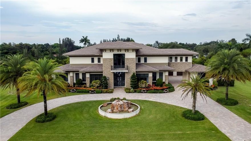 Custom Built Luxurious Estate in SW Ranches. Designed by the renowned Clive Daniel, the interior and exterior features exquisite finishes, artwork, and furniture, all included in the sale except for personal items. Entering to a Double Grand Glass Staircase with views through the great room to the tropical paradise backyard with rock waterfall. Also on the 1st floor is 2 Bedrooms with ensuite, Theater room, Office with Prayer/Gym, Billiards with Lounge room, and Family Room with Kitchen. Take the Elevator to the 2nd floor where the expansive Master Bedroom and 2 Guest Rooms with ensuites feature Steam Rooms in the Showers. Complete Home Sound,Camera, & Generator are just a few of the many features this estate includes. This 2.43 Acre luxurious contemporary estate is a true masterpiece!