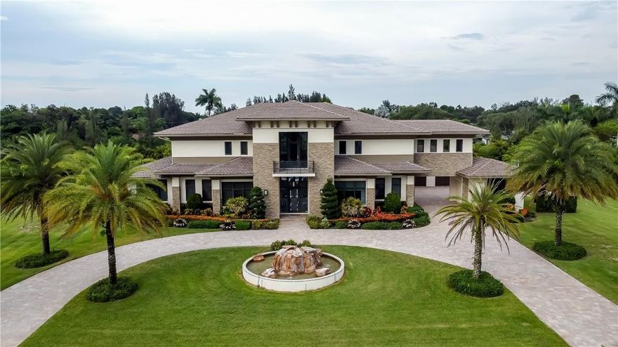 Custom Built Luxurious Estate in SW Ranches. Designed by the renowned Clive Daniel, the interior and exterior features exquisite finishes, artwork, and furniture, all included in the sale except for personal items. Entering to a Double Grand Glass Staircase with views through the great room to the tropical paradise backyard with rock waterfall. Also on the 1st floor is 2 Bedrooms with ensuite, Theater room, Office with Prayer/Gym, Billiards with Lounge room, and Family Room with Kitchen. Take the Elevator to the 2nd floor where the expansive Master Bedroom and 2 Guest Rooms with ensuites feature Steam Rooms in the Showers. Complete Home Sound,Camera, & Generator are just a few of the many features this estate includes. This 2.43 Acre luxurious contemporary estate is a true masterpiece!