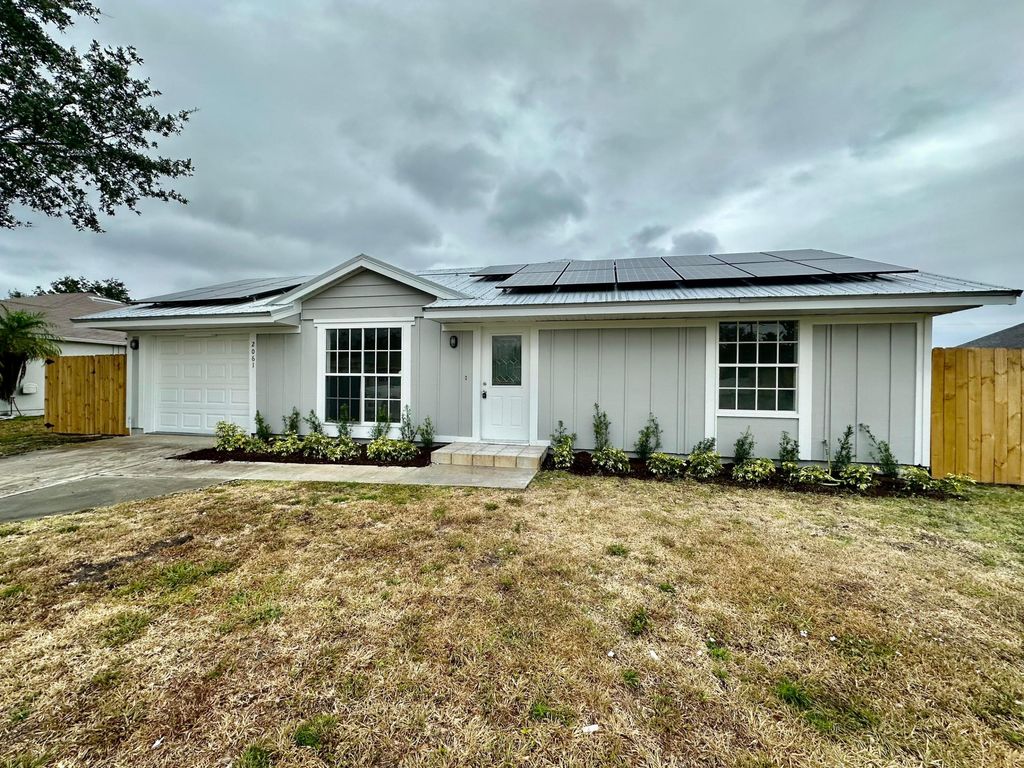 Photo of 2061 SW Burman Lane, Port Saint Lucie, FL 34984 (MLS # R10980853)