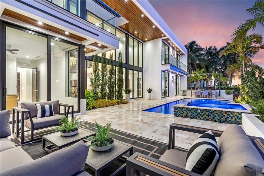 Ultra modern design along 100' of deep waterfront, only 1 from the point. This newly constructed 3 story estate epitomizes the pinnacle of modern architecture & luxury. Soaring 2 story ceilings & walls of glass over looking the waterway command the wow factor upon entering this residence. Smart home technology, cutting edge design & an open flr plan defines todays lifestyle. The custom culinary kitchen opens to a family rm accessing a fully equipped summer kitchen. The ultimate retreat can be found in the lavish master suite with 2 full bathrms, a custom walk-in closet & breathtaking views of the Intracoastal waterway. Outdoor entertaining spaces span across the waterside pool/spa, concrete dock & roof top terrace. Elevator accesses all 3 floors. Optional 5 car garage. Sq ft from developer