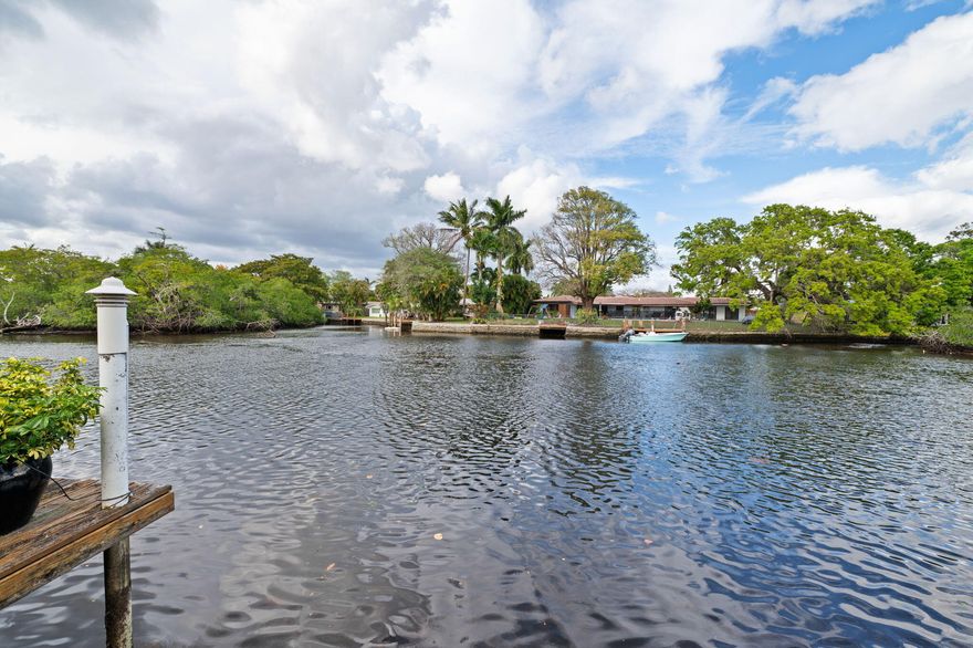 This tranquil waterfront oasis is for the those that desire a relaxing and peaceful lifestyle. The wide views of the flowing Middle River provide an experience seldom found in SOFL.  It is an oversized property for the area and offers a terrific wide open floor plan with the kitchen, living, family and dining areas all offering walls of glass out to the water. The classic and neutral terrazzo flooring can be restored to its original beauty. The primary bedroom offers excellent dimensions and an immense ensuite bathroom.  The exterior is an entertainers delight with the newer pool and travertine deck all set up for maximum exposure to the river. Other benefits include the PVC drain lines, newer AC's, pool heater, termite warranty, carport, impact windows and doors, new window treatments. Sit on the dock, by the pool, in the screened Florida room or in most interior rooms and be mesmerized by the ever changing scene of the beautiful waterway. Watch the wildlife, fish or kayak the Wilton Manors loop for the ultimate naturalistic way of life.  This home is perfectly situated on a very quiet less traveled street but walking distance to Wilton Dr and the entertainment district.