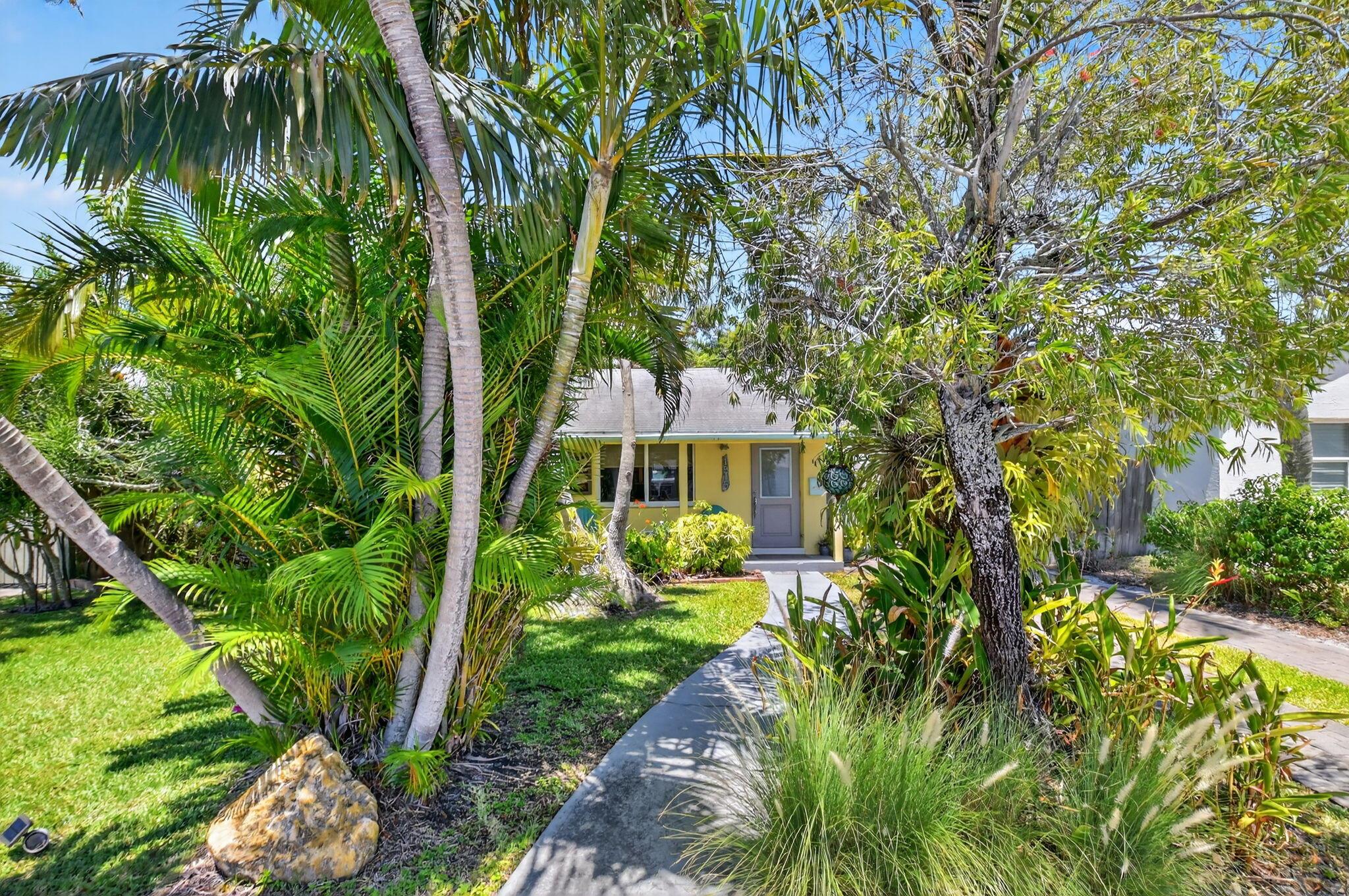 Adorable Key West style cottage home in desirable northeast end of Lake Worth Beach! This charming, concrete, beach-inspired home is one not to be missed. The main house is bright & open with almost all hurricane impact glass windows. Updated kitchen has 2 breakfast bars, stainless steel, granite, a farmhouse sink, and wine/drink chiller. Primary bedroom has a roll-in shower floor and large walk-in closet. Beautiful Terrazzo and tile floors. The detached building behind the house has power, water, is partially air-conditioned, has a huge amount of storage space and the washer/dryer. The private, fenced backyard even has an outdoor shower! Convenient location near wonderful restaurants, Lake Worth Golf Club, shops, entertainment and Lake Worth Beach. Landlord will provide lawncare.