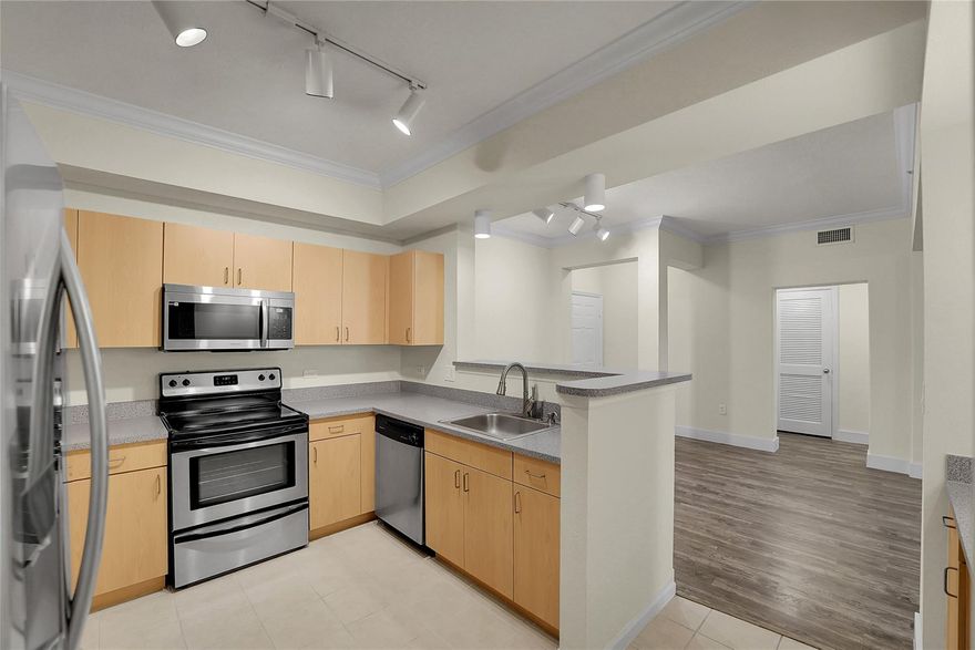 Available for a 6-9 month lease starting now! This top-floor 2 bed 2 bath offers peaceful views on your balcony overlooking the landscaped atrium courtyard. Split-bedroom floor plan, both bedrooms feature spacious walk-in closets. In-unit washer / dryer, impact-resistant windows, a smart thermostat, laminate flooring, modern light fixtures, crown molding, and contemporary finishes. A/C & Water heater (2020). Covered garage parking plus rent that includes WiFi. Amenities include heated pool, fitness center, and rooftop sun deck. Available for immediate lease and just steps from dining, shopping, and vibrant downtown attractions.