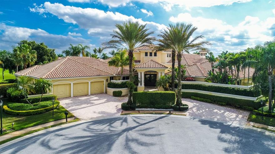 Prepare to be captivated the moment you drive into the cul-de-sac and are welcomed by this impressive Mediterranean home with 280 degree panoramic lakefront views and golf course views in the exclusive community of St. Andrews Country Club. This refined European-inspired masterpiece is situated on a spectacular .86 acre trophy lot. A graceful entry sets the timeless tone of this 5 bedroom, 7.1 bath residence with 7,601 square feet under air. The classic look is fashioned with custom architectural elements, exquisite designer finishes, marble floors and stunning ceiling treatments throughout. The flow functions beautifully for entertaining with French doors to the outdoor living area and private pool and spa in a relaxing resort-like oasis surrounded by huge palms, trees, grass, and lush