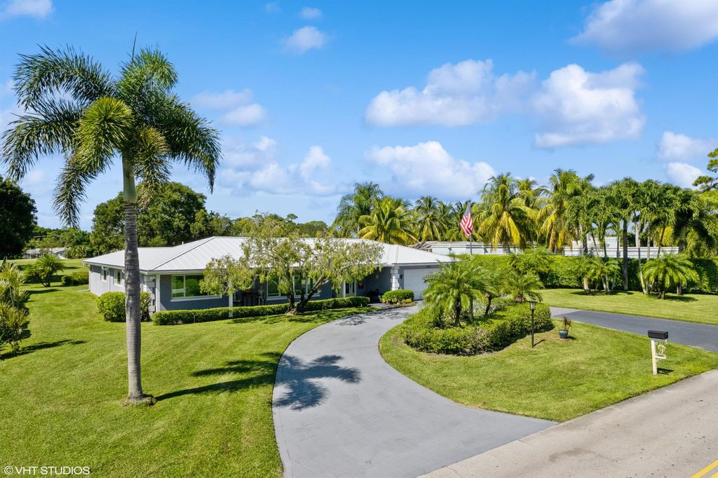 Photo of 285 N Country Club Drive, Atlantis, FL 33462 (MLS # R10928243)