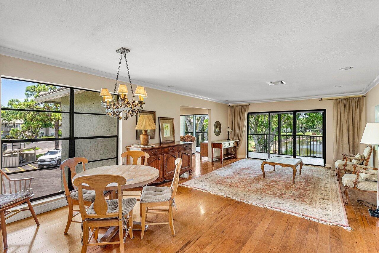 Step into this beautifully furnished condo in the exclusive Hunters Run Country Club in Boynton Beach. This second-floor corner unit offers peaceful water views and is filled with natural light, creating a warm and welcoming atmosphere. The home features two spacious bedrooms, two updated bathrooms, and a versatile bonus room perfect for a home office, guest space, or creative studio. The kitchen is equipped with custom wood cabinetry and stainless-steel appliances, ideal for both everyday living and entertaining. A combination of wood and carpet flooring adds comfort and charm throughout the residence.Enjoy the convenience of being just minutes from vibrant downtown Delray Beach and the area's pristine white-sand beaches--perfect for embracing the best of South Florida living.