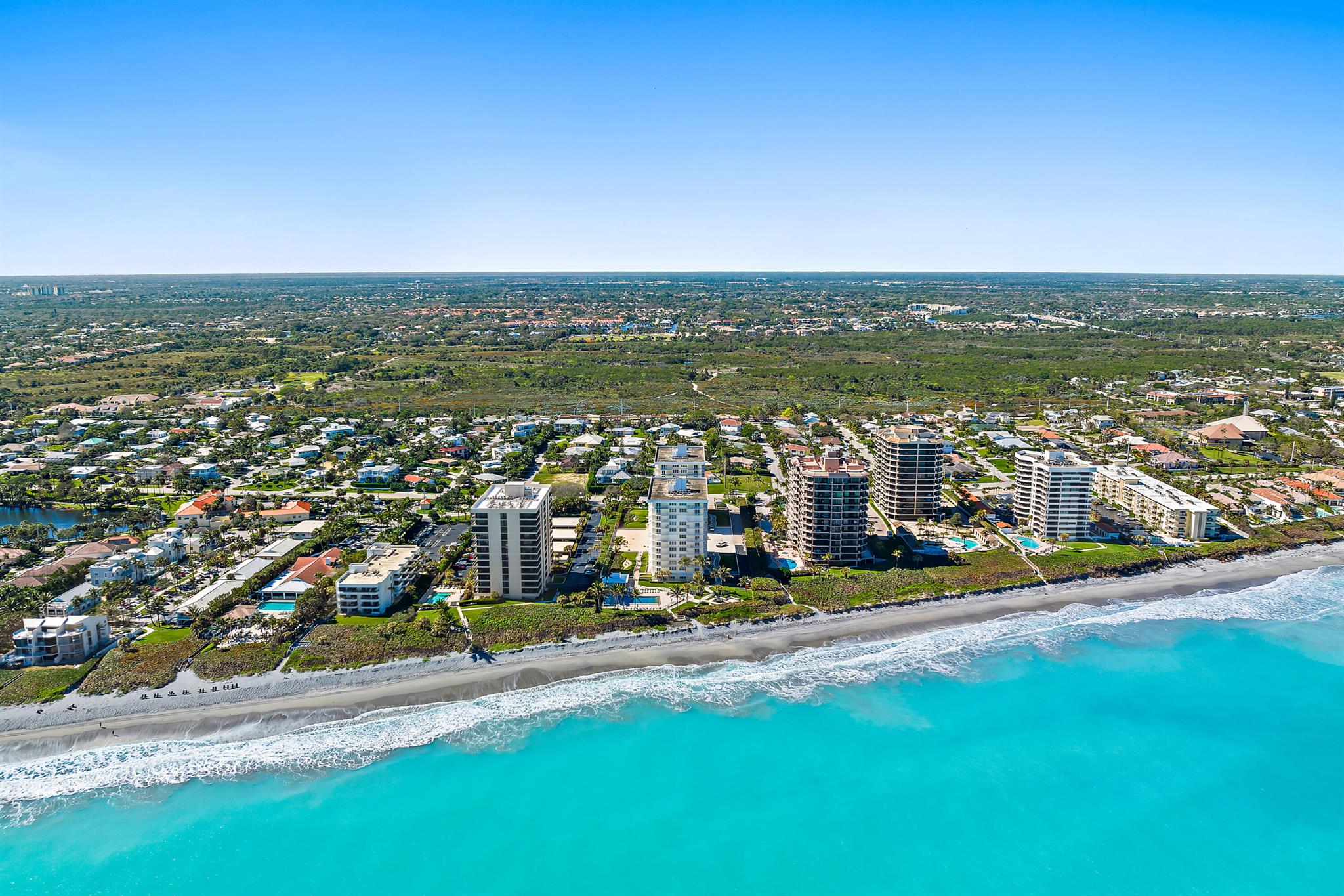 Situated directly on the ocean with the most spectacular views from every room, this 9th floor unit offers complete hurricane protection with new impact windows and sliders. Both bedrooms each have their own completely renovated en-suite bathrooms. Fresh paint, new kitchen appliances with gray subway tile backsplash, FULL size washer/dryer and newer carpet in the bedrooms, this rarely lived in unit has been well-maintained throughout the years. Brigadoon is a structurally sound & extremely well-kept property. Walking distance to the Juno Beach Pier, Pelican Lake, Loggerhead Marine Life Center, restaurants & shops. Brigadoon provides gated security, underground parking...