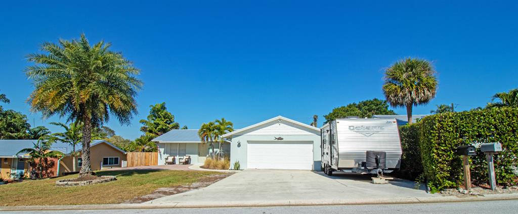 Costal Beauty located in the heart of Hobe heights. Exterior well maintained with tropical landscaping. Two car garage updated with painted flooring. Roof replaced 4 years ago, serene backyard with covered patio. Inside displays costal style with new flooring throughout. White kitchen with stainless steel appliances. 3 bedrooms and 2 full bathrooms updated. Bike ride away from local beach and boat ramp, walking distance to neighborhood park with basketball court.