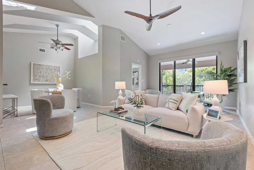 Welcome Home! You’re going to fall in love w/the open layout, cathedral ceilings & skylights which create a bright & airy flow throughout. Hunter Douglas blinds add a touch of class & ~YES~ those are 2 Big Ass Fans (literally!) offering both style & comfort. The bathrooms are generously sized & modern w/beautiful mirrors that elevate the design. Both bedrooms are comfortable in size & include closet built-ins for maximum storage. The primary suite features a stylish new barn door that opens to a beautiful spa-like bathroom & a walk-in closet. Enjoy the views of the lake & the lush, park-like grounds from the living area & primary bedroom. “Wine down” at the end of the day on your spacious screened-in patio ~ the perfect, serene place to relax. CHECK OUT THE VIDEO TOUR ABOVE!