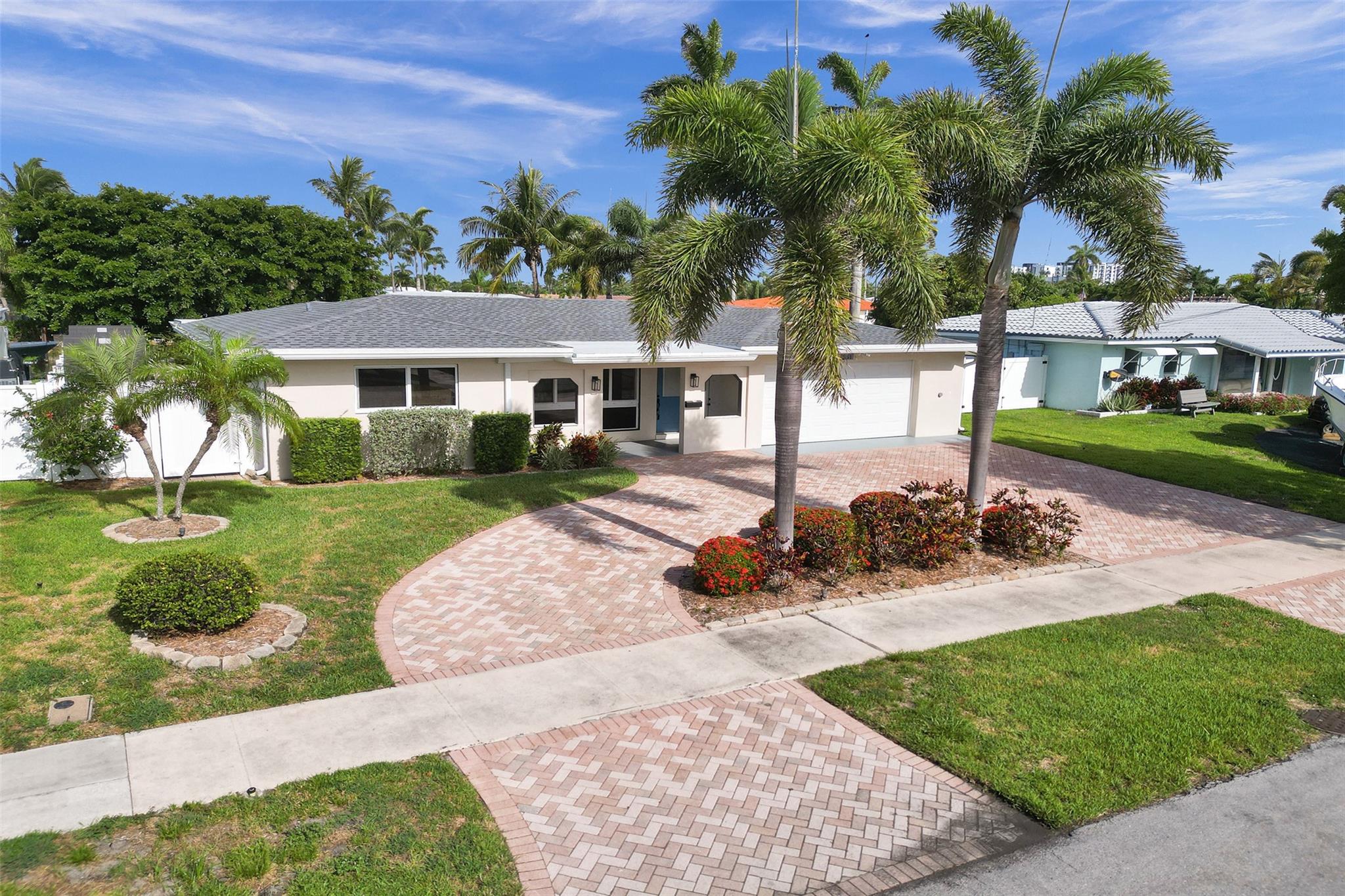 Enjoy relaxed coastal living in one of Pompano Beach’s most desirable waterfront communities. This hidden gem offers 75 feet of water frontage on a wide canal with easy access to the Intracoastal and beyond. The tropical backyard is perfect for entertaining, complete with a sparkling salt water pool, hot tub, and built-in outdoor gas fireplace. Inside, you’ll find a comfortable, light-filled layout with a tastefully upgraded bathroom, impact windows, French doors, and ample storage. Additional highlights include a 2-car garage with extra storage closets, a 2021 roof, 2023 AC, PVC fenced yard, 3 sheds and a circular paver driveway. Ideal for boaters and those who love the Florida Lifestyle - just minutes to Pompano Beach Pier, beaches, shopping, dining, and marinas.