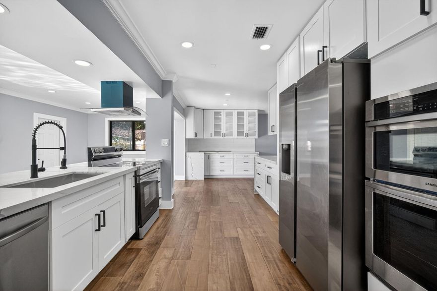 No HOA – No Restrictions!Stunning 3-bedroom, 2-bath home plus Florida room, oversized laundry room, and outdoor bath. This redesigned home features an open-concept layout, a fully updated kitchen with Shaker wood cabinets, double oven, exhaust hood, and modern finishes. Stylish bathrooms and new wood flooring flow throughout the home. Upgrades include impact windows, newer roof, upgraded electrical, recessed lighting, new fence, fresh interior and exterior paint, new sod, and a new pool pump. Enjoy a circular driveway, a ginormous laundry room with counters and cabinets, and a home that blends modern comfort, quality craftsmanship, and timeless style. Move-in ready!