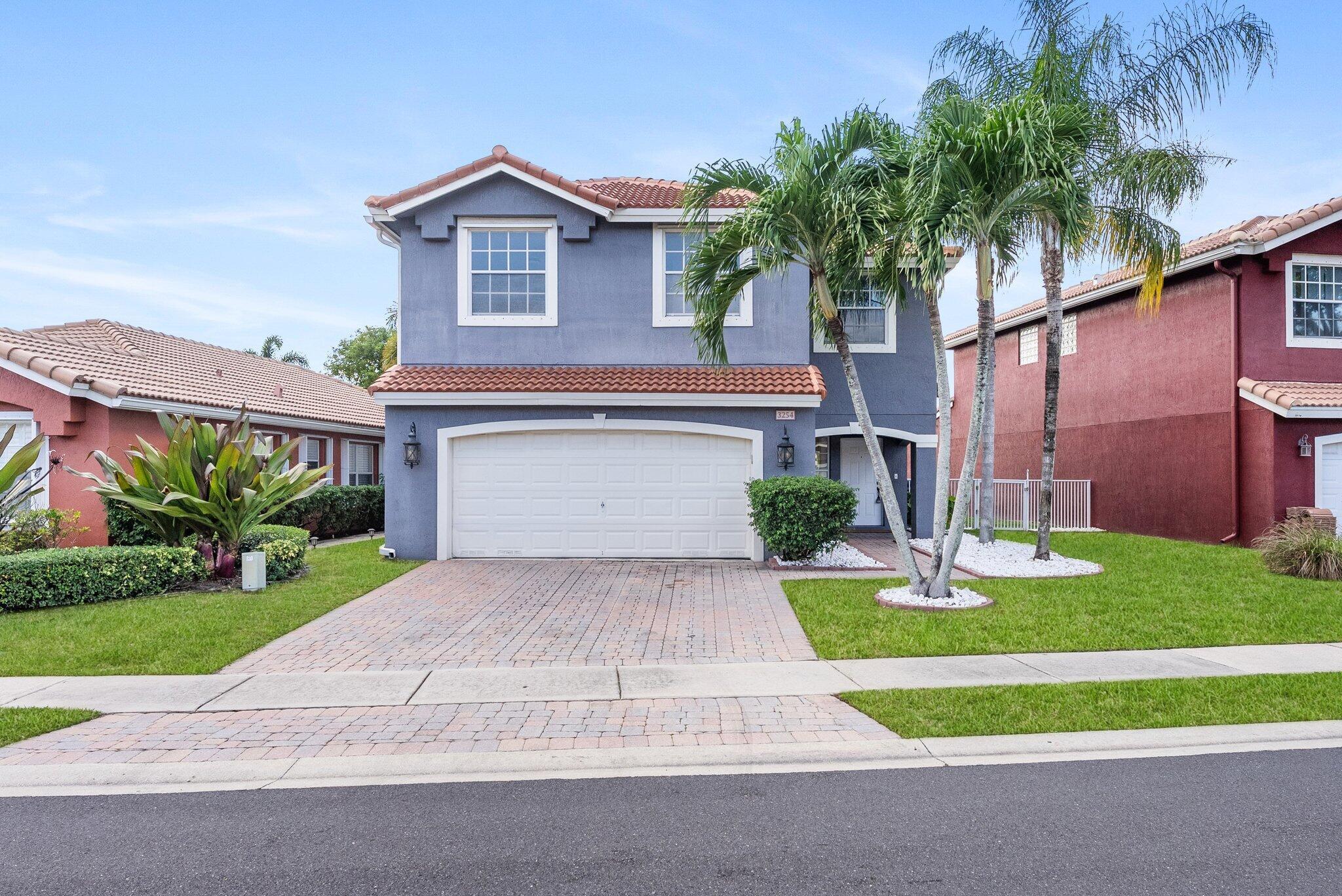 Impeccably renovated 4BR/2.5BA residence with 2-car garage in the gated community of Briar Bay, West Palm Beach. Features a 2023 roof, 2018 A/C in excellent condition, and water heater under 2 years. Modern vinyl patio doors open to elegant living spaces with remodeled baths, stylish flooring, and an open-concept layout. The designer kitchen offers stainless appliances--all new or under 2 years--custom cabinetry, and quartz counters. The backyard is an entertainer's paradise with an in-ground pool featuring a waterfall option, covered grill/fridge area, and paver landscaping. Resort-style amenities include pool, tennis, gym, and playgrounds.