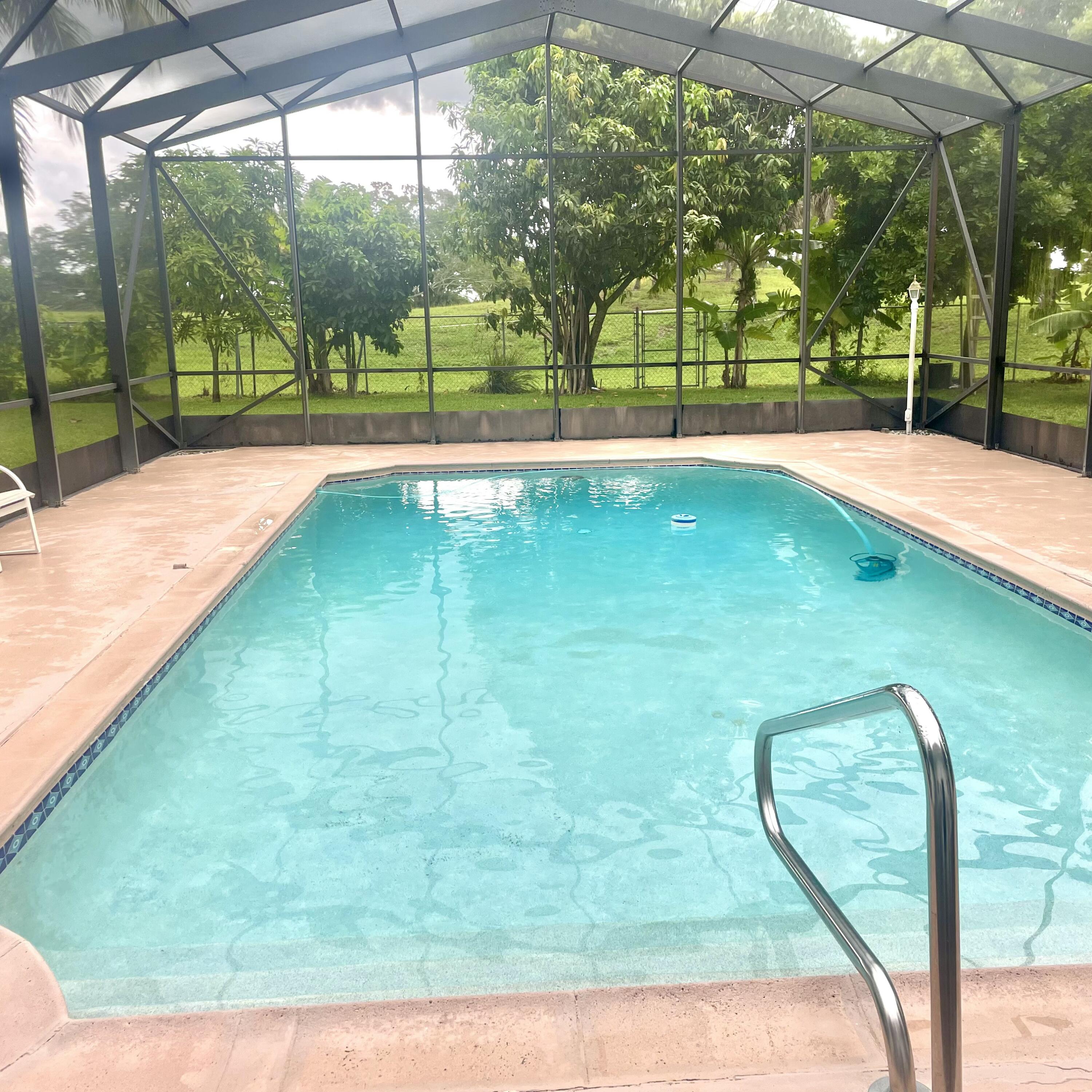 Stunning 2BR, 1BTH home w/large screened-in pool area & large backyard. Prime location, friendly neighborhood, close to top rated schools & shopping. This beautifully maintained home combines modern comfort & luxury. The screened-in pool area is perfect for year-round swimming, exercise, and relaxation, outdoor dining, rain or shine. Landscaped & fenced for privacy and safety. Enjoy fresh citrus with mature fruit trees right in your own yard. Convenient location to shopping. Kitchen features contemporary fully furnished & laundry area, energy efficient windows & lighting. This well maintained home includes a 2 car garage.