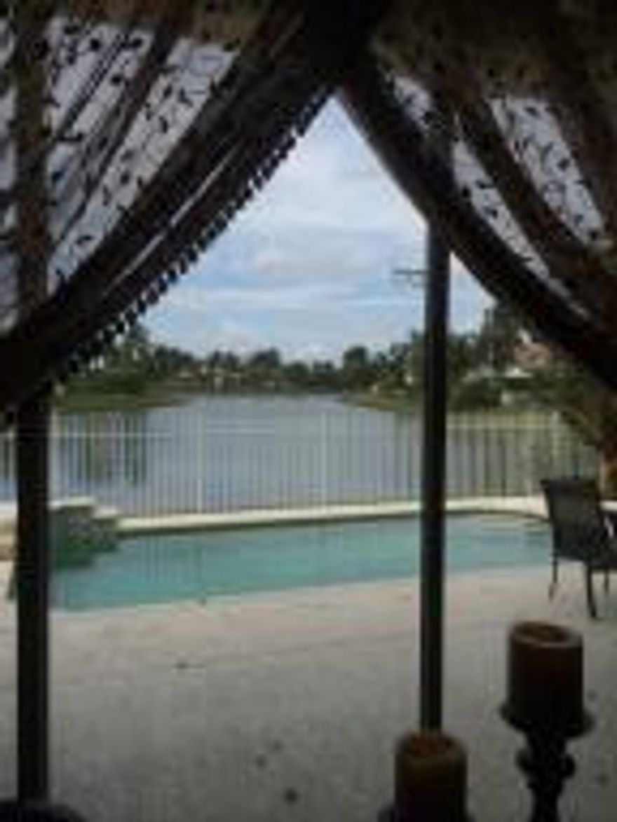 BOCA ISLES NORTH 4/2 LAKE FRONT HOME. HEATED POOL, NEWER ROOF, UPDATED KITCHEN WITH SS APPLIANCES AND PULL OUT DRAWERS, NEWLY RENOVATED SECOND BATH. HURRICANE SHUTTERS, HURRICANE PROOF GARAGE DOOR, WOOD LAMINATE FLOORS THROUGHOUT, CENTRAL VAC, LONG LAKE VIEWS FROM PATIO. PRIDE OF OWNERSHIP THROUGHOUT. SECURITY SYSTEM. NOT A SHORT SALE. OWNER CAN CLOSE VERY FAST.