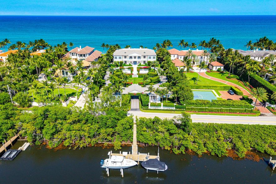 The Beach House is a neoclassical estate in Manalapan spanning 1.86 acres, boasting 155 feet of direct ocean and Intracoastal frontage. This 22,220 sq. ft. property features three homes: the Main House (7 bedrooms, 9.4 baths), South Guest House (2 bedrooms, 2.1 baths), and North Guest House (2 bedrooms, 2.1 baths). Arriving via a lushly landscaped driveway, visitors are greeted by grand terraces and striking dual water views. Upon entry, the foyer opens to breathtaking vistas of the expansive pool, manicured lawn, and ocean, enhanced by elegant, island-inspired landscaping. Architect: Smith & Moore. Builder: J5. Interior Design: Marc Michaels The Main House (14,899 Sq Ft U.A.) Upon entry, be welcomed by dual water views of the ocean and intracoastal, a grand staircase, custom inlaid marble flooring, and smoked glass columns. With His/Her powder rooms off the foyer, enter the formal living room, exquisitely decorated with custom furniture, a backlit marble fireplace, and lacquered walls. The main gallery connects all rooms on the main floor, leading you to the North wing, which includes the kitchen, family room, and breakfast room, all overlooking an oversized covered loggia. All rooms on the main floor can be separated or closed off. The South wing includes a VIP Bedroom Suite with a private entrance to the loggia, statuary marble dual vanities, and floor-to-ceiling windows. A secondary bedroom overlooks the west side of the estate with custom shelving and natural light.  Ascending the grand staircase, the landing leads you to the Master Bedroom Suite on the southeast wing of the upper level and 4 additional bedrooms all en-suite. Enter into a private foyer immediately greeted by subtle grandeur, ocean views, an expansive terrace, and custom millwork throughout. The Master bedroom, including a seating area and fireplace, flows into the master sitting room/breakfast bar, closets, and bathrooms. Her sanctuary opens up into a massive closet and oceanfront bathroom featuring a Mother of Pearl oyster shell chandelier, soaking tub, inlaid marble, and balcony. His closet connects to a spa-like bathroom, including a metal frame rain shower. The gym is connected to both master closets and bathrooms for easy, but private access. On the North end of the upper level, there are two oceanfront bedrooms and one garden view bedroom all with access to expansive covered loggias. The fourth bedroom overlooks the garden and can be used as a flex space.   Descending an additional grand staircase to the lower level, a temperature-controlled wine room is located at the bottom of the stairs leading to an additional staff bedroom or flex room. This fully finished, air-conditioned garage fits 5+ cars and is attached to the main house.  Guest Houses (1,487 Sq Ft U.A./ 993 Sq Feet U.A.) Crossing over the sprawling lawns and coral stairs, you will find South & North Guest Houses on the west side of the estate, both with their own private garden. The South GH features a family room, dining room, full kitchen & 2 bed/2.1 bath layout. The North GH includes 2 beds/2.1 baths and a catering/chef's kitchen. The entire property is walled, gated, has enhanced security and a smart home system.  Enjoy easy access to the Intracoastal with your own private dock with two lifts, perfect for water sports and yachting.  Manalapan is one of Florida's most exclusive enclaves in South Florida, home of the famed Eau Hotel and Nobu Manalapan.  Shopping, golf, tennis, and multiple restaurants are within walking distance or a short drive.  Manalapan is conveniently located in the middle of Palm Beach County, placing it minutes away from Palm Beach, Delray, and Boca.  Private aviation FBOs close by offer several options within minutes (helicopter/private) and close by international airports like Palm Beach International, Fort Lauderdale and Miami are less than an hour.   Manalapan became known when billionaire Harold Vanderbilt decided to make it his home.  It has since become the home of numerous famed billionaires and is considered one of the rarest stretches of land in South Florida due to its ocean-to-Intracoastal access, privacy, and has approximately 400 residents.  It is also known for its sport fishing, diving, and snorkeling.    DISCLAIMER: Information published or otherwise provided by the listing company and its representatives is deemed reliable but not guaranteed and is subject to errors, omissions, or changes without notice. All information should be independently verified by any prospective buyer or seller. Listing company expressly disclaims any warranty or representation regarding such information.