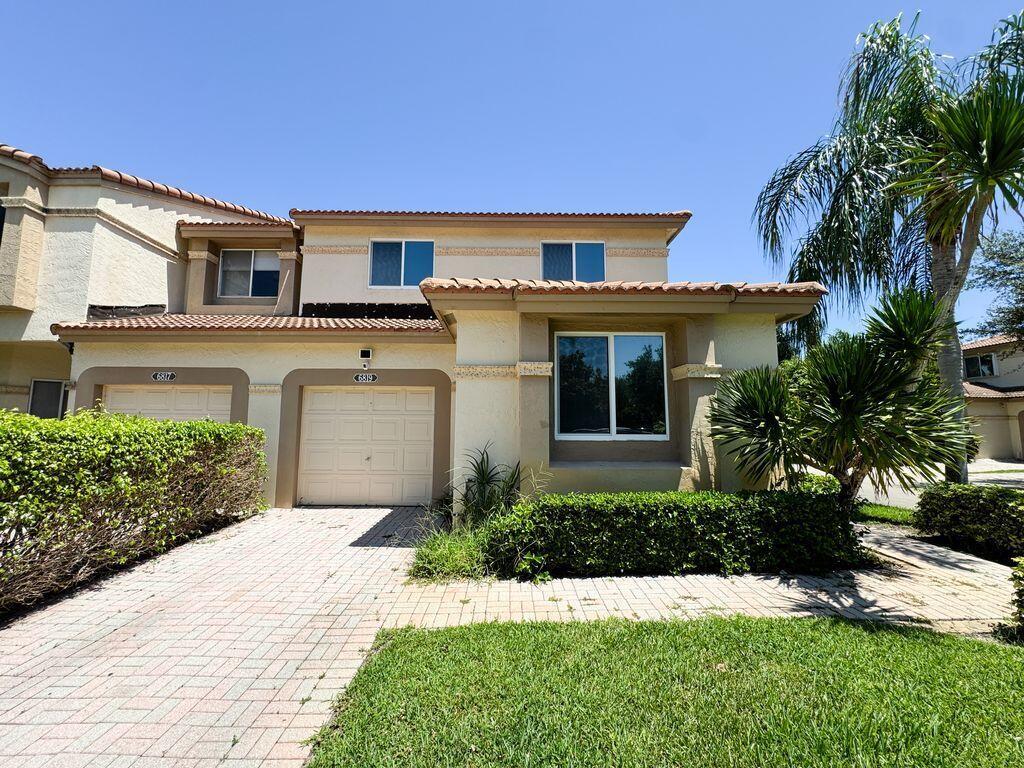 Fully Furnished - Largest End Unit with Garage in Cortina, Boca Pointe. Enjoy luxury living in this prestigious gated Country Club community where memberships are optional. This expansive residence offers a remodeled gourmet kitchen with French-style cabinetry, granite counters, center island, stainless steel appliances, and dual sinks. Elegant touches include stone-look tile, plantation shutters, and a chic powder room. Upstairs, the oversized master suite features a walk-in closet, quartz double vanity, soaking tub, and seamless glass shower. Impact windows & sliders, new flooring, washer & dryer in-unit, and over 2,100 sq.ft. plus a screened porch. Community pool and walking distance to places of worship. Optional golf, tennis, fitness & social memberships available.