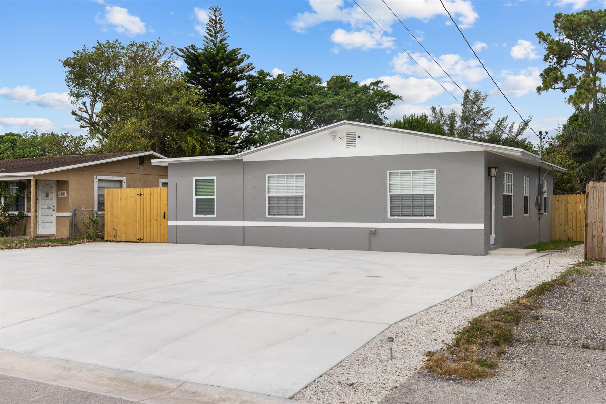 Remodeled 3 bedroom with attached complete 1/1 or can be used as a 4/2. New permitted Large shed Can be converted to a 1/1. Roof 2018 Ac 2020. 2 new kitchens and bathrooms all new flooring. Parking for 10 cars on all new concrete. Great location with no HOA!!! Perfect for primary residence or great income producing property. 3/1 2700.00 1/1 1400 and addition 1400 for the outside building that needs finishing. Expected income of 5500 and you can place your own tenants