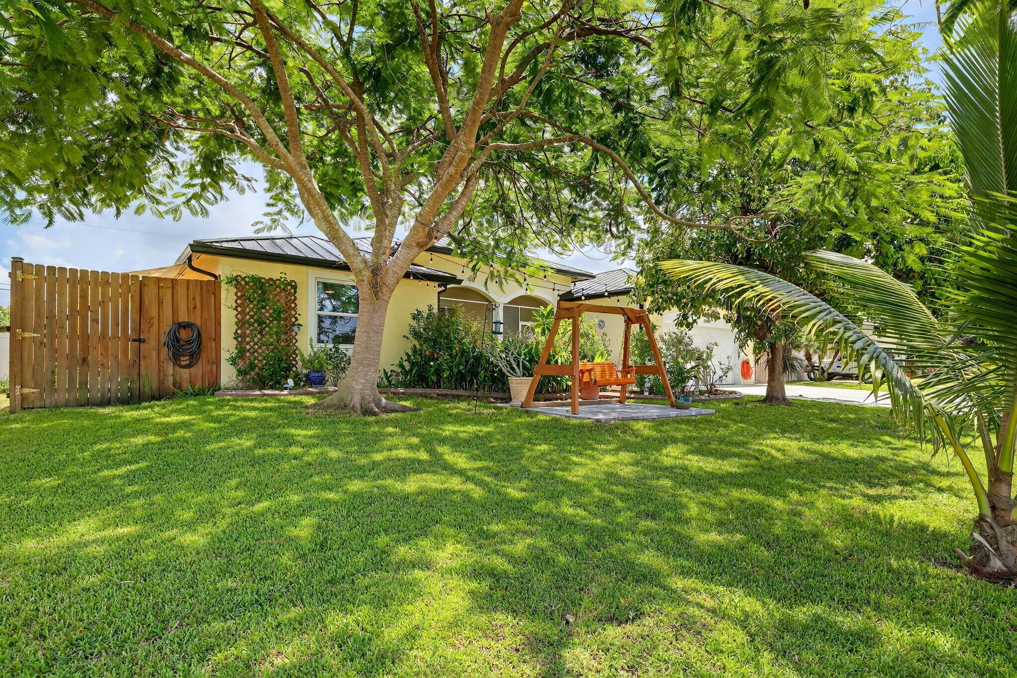 Live in your own tropical paradise with this updated 4/2/2 home with POOL and SPA in beautiful Port St Lucie, FL. Featuring a saltwater pool with attached spa hot tub, and surrounded by mature fruit trees, this property is perfect for living the Treasure Coast lifestyle. Enjoy a spacious split layout that boasts 2100+ sqft of living space with wood-plank tile in the main living areas, and high volume ceilings throughout. Entertain your guests with a modernized gourmet kitchen featuring granite counters, plenty of storage, and a functional layout. Brand new standing seam metal roof system, 8 ft privacy fence, hurricane impact windows, irrigation, EV Charging Station, expanded driveway, and a brand new A/C will give you all the piece of mind you need! PLUS No HOA, so bring all your toys!