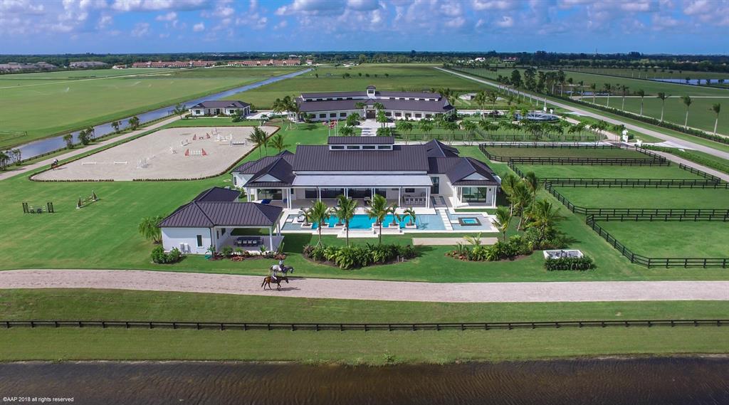 This custom built gated equestrian property in Wellington Preserve has it all! The main house is bonded lightning protected with 4 bedrooms (+ office), 4 full bathrooms and a large (41'x26') 3 car garage. All of the windows and doors are impact rated. Milano Italian doors throughout. The great room has an open beam ceiling and skylight and beautiful porcelain wood flooring throughout. House has fully automated audio, video, pool & lighting system. The spacious master bedroom has automated blinds over 10 ft glass slider walls overlooking the pool area. The master bathroom has his and hers sinks, walk in shower and outdoor shower, tub with picture windows, Toto electric toilet and bidet. The master walk in closet has safe room built ins.