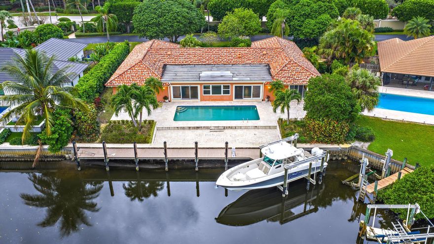 Gorgeous waterfront home opportunity in Palm Beach Gardens! Spanning nearly 4,000sqft, this 4BD/3.5Ba home with 2 car garage sits on a wide canal offering direct intracoastal and ocean access with NO FIXED BRIDGES and a private dock with electric, water, and hoist/ davit in place, A TRUE boaters dream! The view spans the entire length of the canal. This property is being sold AS-IS, and presents an incredible ideal waterfront retreat. Located on a quiet street within one of the most desirable neighborhoods in Palm Beach Gardens, this amazing property is just minutes from beaches, dining, golf, and premier shopping, it's the perfect blend of location, lifestyle and opportunity.