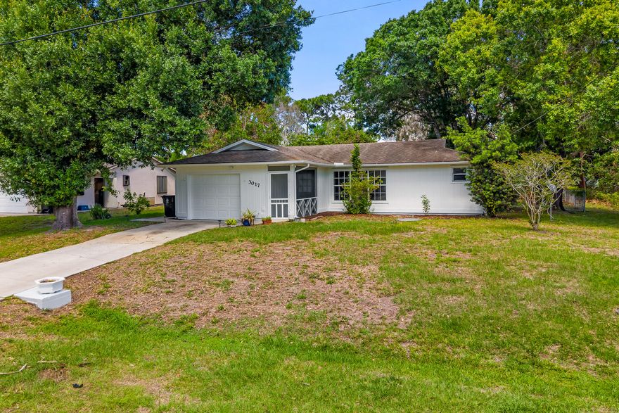 Nobody can EVER build directly behind you! This charming, and well-maintained, home with over 1,500+ TOTAL SQFT backs up to a very wide storm drainage canal which keeps backyard neighbors far away, forever! High and Dry, and no flood insurance required! FULLY-FENCED backyard with multiple gates! Mature trees offer plenty of shade allowing you to enjoy your yard even in the heat of the Summer. Fresh exterior paint! Split and open floor plan, with kitchen island w/electricity, makes the home great for entertaining. Only +/-4 Minutes away from a wholesale club, grocery stores, restaurants, home improvement stores, and more! About 10 minutes to I95, Tradition Village Center, and Tradition Hospital! Call today for your showing, and MAKE AN OFFER! The home is ready for its new owner!