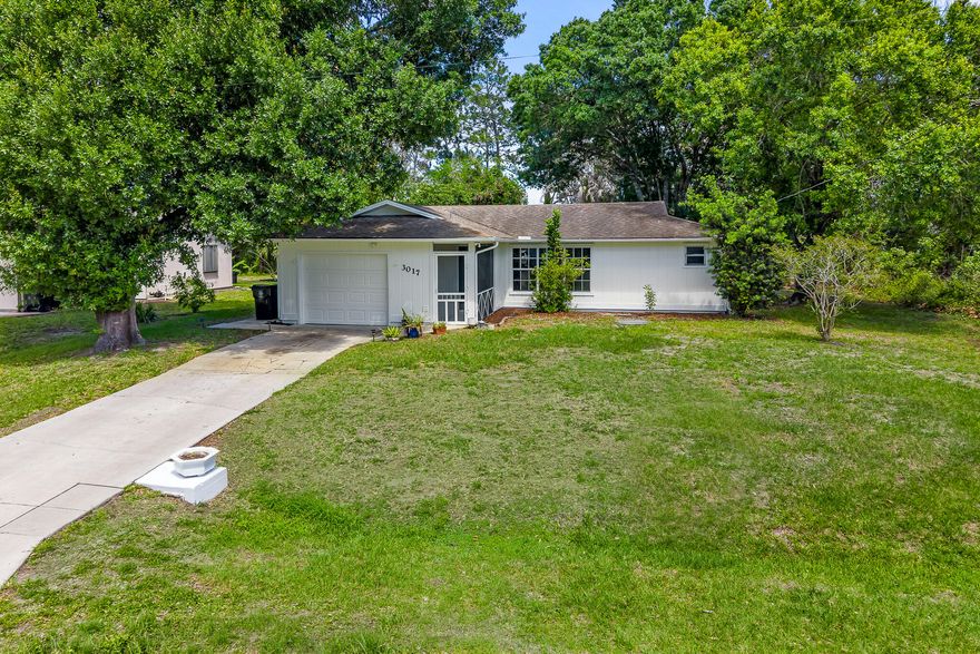 Nobody can EVER build directly behind you! This charming, and well-maintained, home with over 1,500+ TOTAL SQFT backs up to a very wide storm drainage canal which keeps backyard neighbors far away, forever! High and Dry, and no flood insurance required! FULLY-FENCED backyard with multiple gates! Mature trees offer plenty of shade allowing you to enjoy your yard even in the heat of the Summer. Fresh exterior paint! Split and open floor plan, with kitchen island w/electricity, makes the home great for entertaining. Only +/-4 Minutes away from a wholesale club, grocery stores, restaurants, home improvement stores, and more! About 10 minutes to I95, Tradition Village Center, and Tradition Hospital! Call today for your showing, and MAKE AN OFFER! The home is ready for its new owner!