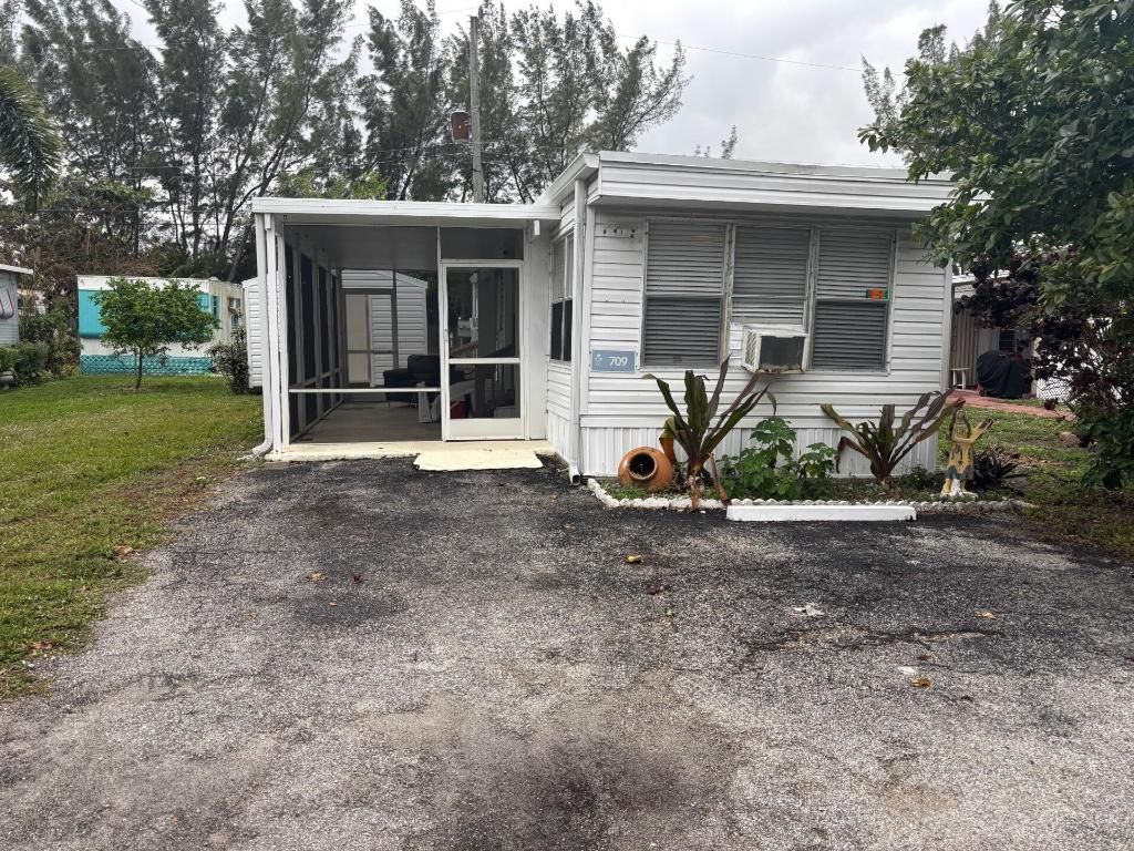 Photo of 709 NW Almond Drive, Lake Worth, FL 33461 (MLS # R11155796)