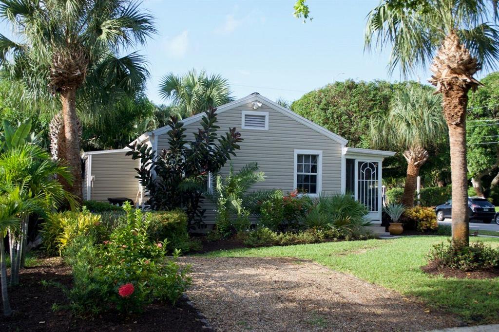 ENDEARING cottage home on a corner lot. Hard wood floors, upgraded bathroom, new siding with 50 year warranty, newer air conditioning, new appliances, granite countertops, updated windows, newer roof. Screened front porch, the yard is meticulously kept and private, fully fenced back yard (white picket), with mature trees, including a mango and avocado. Hurricane rated storage shed. The home is located in Historic Pineapple Park, close to City Place, Howard Park, The Armory Art Center, The Kravis and Convention Centers, Palm Beach International Airport. This is a private oasis and a we welcome you to come take a look!
