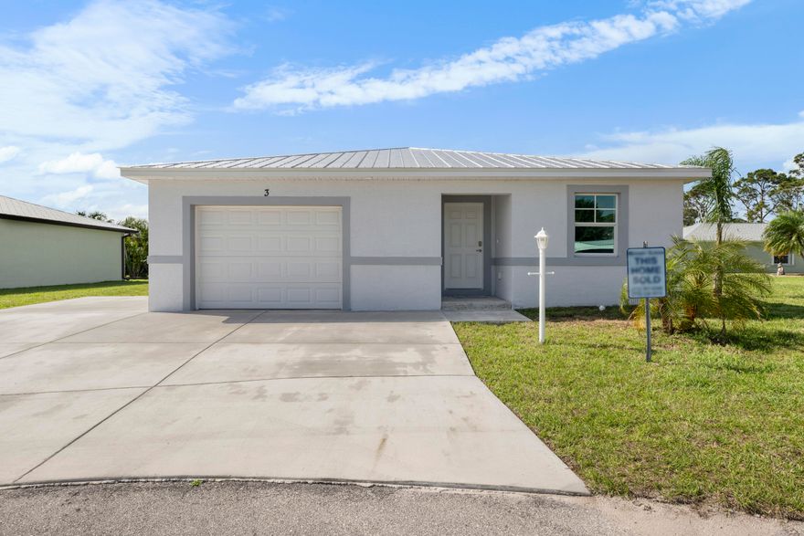 This charming Cottage floorplan blends cozy comfort with spacious versatility, featuring a large open concept layout, 1 bedroom plus a bedroom sized den, and 1.5 baths, thoughtfully designed with hurricane-impact windows, metal roofing, and luxury finishes throughout. The den makes an ideal guest room, office, or hobby space, with space-saving pocket doors and a large window overlooking the back yard. The oversized master bedroom and spacious walk-in closet have vaulted ceilings and the ensuite is complete with quartz countertops and tile floor. The kitchen will feature a matching 1 level quartz peninsula Bar Top with enough length to seat at least 4 and an undermounted sink with a matching quartz backsplash. Guaranteed Fixed long term land lease: $729/month for 99 years.