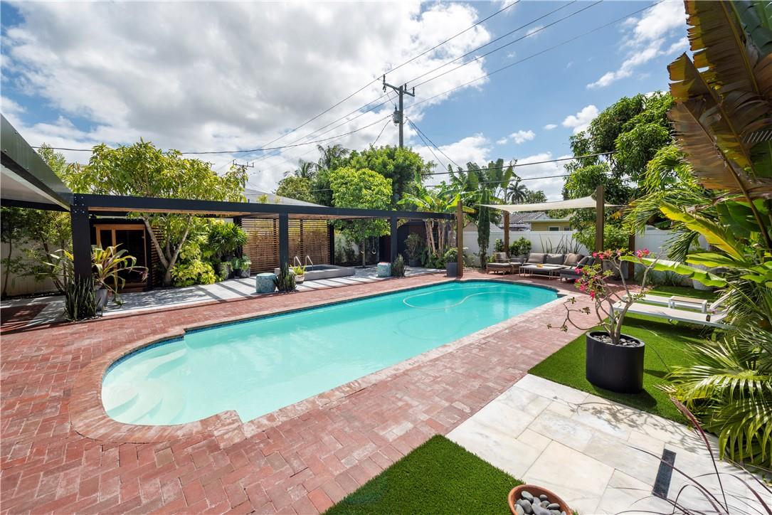 This stunning and completely remodeled 2/2 plus den home looks like something featured in a magazine. Located just minutes from Wilton Manors nightlife, downtown and the beach this open floorplan dazzler offers polished terrazzo and tile flooring, beautiful kitchen with cherry cabinets, impact windows, Master BR w/skylight, a den/office/3rd BR with custom closets and trim throughout. A spacious great room overlooks a magical resort like private back area featuring a gorgeous pool w/ lanai, custom covered outdoor kitchen and seating area for entertaining, a sauna and cold-water plunge pool, outdoor shower, custom lighting and landscaping and separate shed. Newly pavered front entrance! This special home is perfect for your homestead, second home or even as a vacation rental. A must see!
