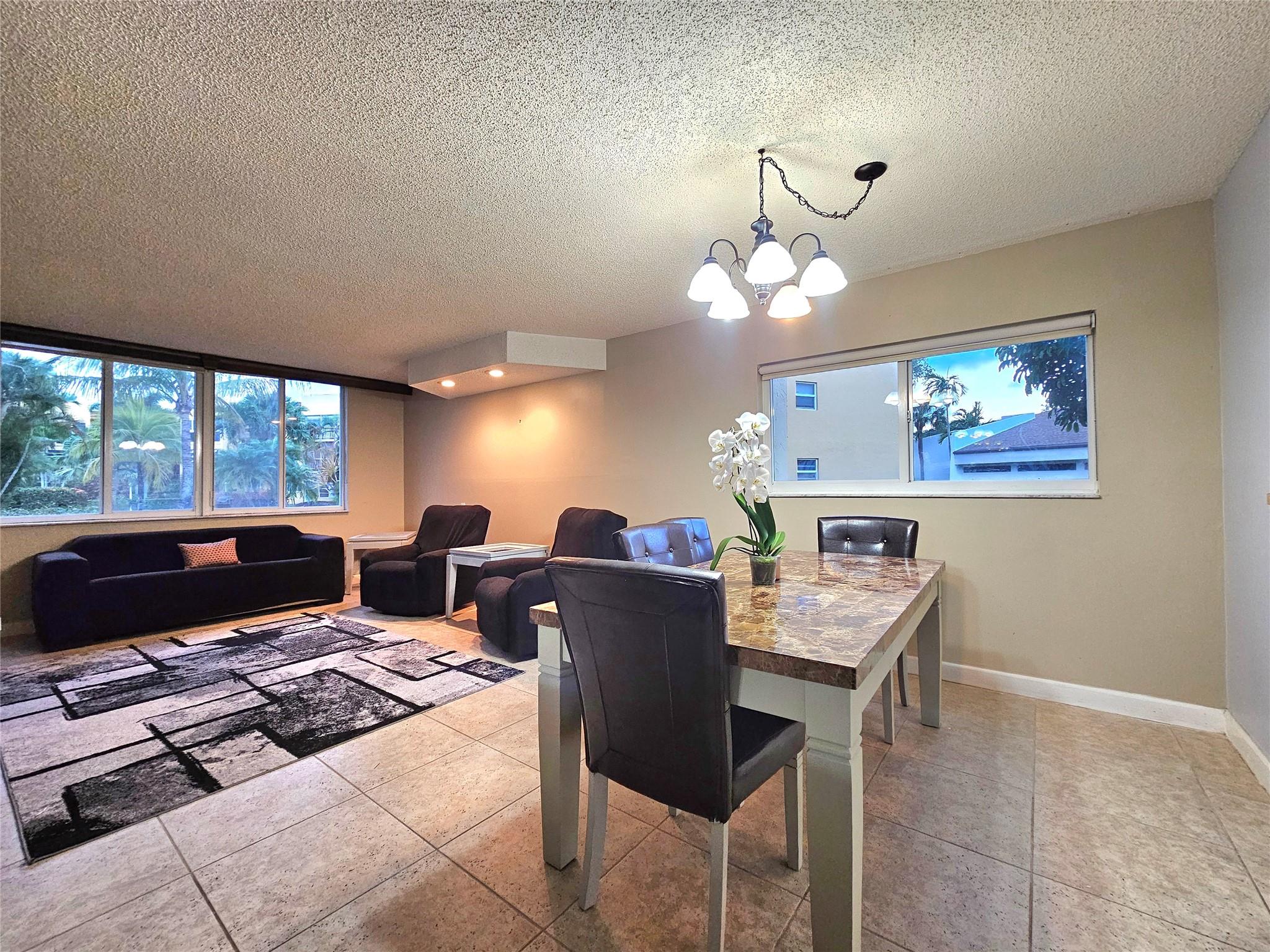 SPACIOUS 2 BEDROOM, 2 BATH, CORNER UNIT ON THE FIRST FLOOR, IS CONVENIENTLY LOCATED STEPS FROM THE POOL, THE CLUBHOUSE, SHUFFLEBOARD AND THE PICNIC AREA. YOUR PARKING SPACE IS RIGHT OUTSIDE YOUR FRONT DOOR!! THE KITCHEN HAS AMPLE AMOUNTS OF CABINETS AND COUNTERTOPS WITH AN ENCLOSED SUNROOM ATTACHED TO ENJOY YOUR MORNING COFFEE AND GREET THE DAY. LARGE LIVING/DINING AREA TO ENTERTAIN YOUR FAMILY AND GUEST WITH TRANQUIL GARDEN VIEWS. THE PRIMARY ENSUITE IS LARGE ENOUGH FOR A KING SIZE BED AND HAS A LARGE WALK-IN CLOSET TO ORGANIZE ALL YOUR BELONGINGS. YOU ALSO HAVE AN ENCLOSED, FUNCTIONAL LANAI WITH ACCESS FROM EITHER THE SLIDING DOORS OFF OF THE PRIMARY BEDROOM OR FROM YOUR LIVING ROOM. THIS IS A 55+ COMMUNITY LOCATED IN MARGATE AND CLOSE TO RESTAURANTS, GROCERY STORES & MEDICAL FACILITIES.