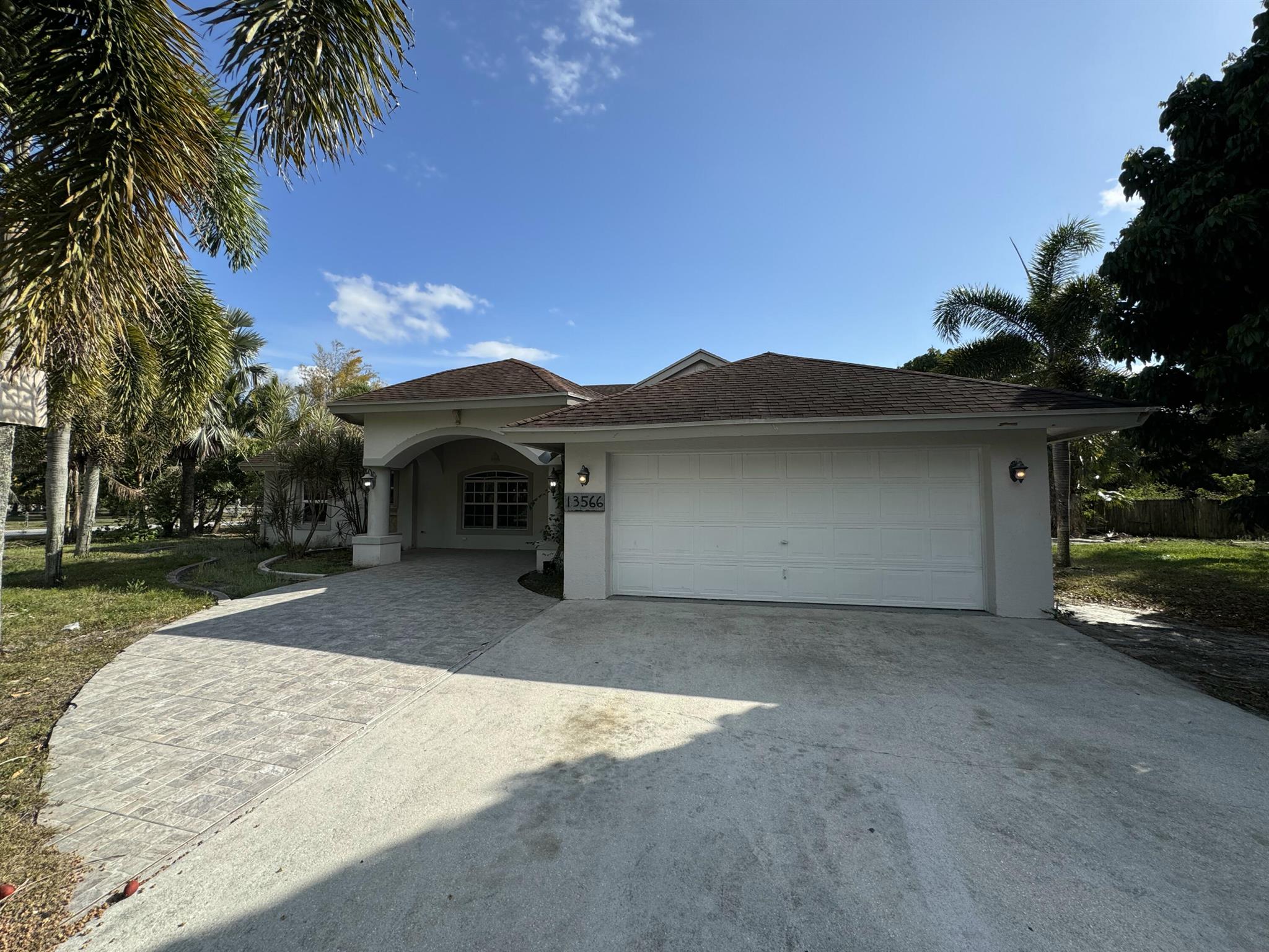 1.3+ acres in The Acreage! This 4 bedroom 2 bathroom home with over 2,000 SF under air. Large yard on a corner lot, gated driveway, oversized 2-car garage. Entry opens up to informal living spaces and an open kitchen with high ceilings. Split plan places the primary bedroom away from the 3 guest bedrooms with private ensuite and walk in closets. Large backyard with covered areas for entertaining.