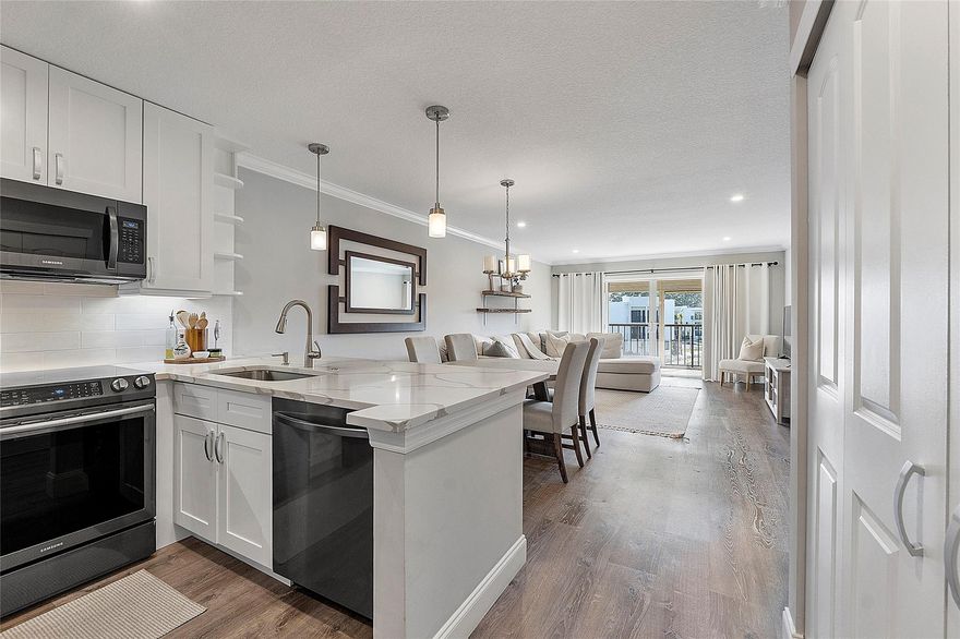 Welcome home! Your remodeled sophisticated Pottery Barn influenced condo awaits you! Featuring wide wood plank flooring throughout living/bedroom/kitchen. Kitchen features beautiful quartz countertops, an extended coffee bar w/ ample countertop/storage, new charcoal Samsung appliances, shaker cabinets w/ upgraded hardware, kitchen storage closet w/built-in cabinetry & marble countertop, pullouts in pantry. Curtains in living/bedroom stylish/blackout, the living/dining is generous in proportion. The Spa-like bathroom w/ a barndoo/seamless shower, magazine quality vanity, custom wood shelving & Ig mirrored medicine cabinet Luxurious bedroom w/ a 3 door large built-in wardrobe. Sunlight balcony spacious & serene w/ wood detailed ceiling. Impact windows. Samsung washer/dryer.