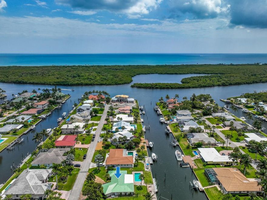 Incredible opportunity to live the Florida waterfront lifestyle! Home for your Yacht - 100 ft of waterfront paradise on deep water 100' wide canal, 6 homes from the Intracoastal Waterway. The perfect place to moor your boat and enjoy ''bridgeless'' access to ocean. Remarkable features that make this property a true gem: Concrete seawall + 40 foot dock w  xtra large/high pilings to moor up to 60ft boat. +21 ft slip in area of the davits for jet skis or 14ft boat. Solid CBS construction, impact doors/window, hickory floors, big master w walk-in closet his/hers vanities, central vacuum, lots of living space, plantation shutters, built-in book cases, extra large 2 car garage. Experience thrilling water sports adventures from your backyard. The Pine School (pre K - 12) 3 miles and the boat ramp at Jimmy Graham Park is less than 1.5 miles away. For those who enjoy paddle boarding or kayak there's ample space to store your gear, and it is less than 2 miles to paddle to the beach.. This parcel truly hits a home run for boating and water sports enthusiasts. Not only does this property offer an exceptional waterfront experience, but it also provides easy access to some of Florida's most breathtaking beaches. Just a 3 mile walk, bike, or drive away, you'll discover Hobe Sound Beach.one of the best beaches in Florida, complete with miles of uncrowded shoreline. Whether you want to relax under the sun or take a long walk with your furry friend in the dog-friendly area, this beach has it all. Explore the nesting sea turtles, engage in exciting snorkeling adventures, or cast your fishing line from the shores. The possibilities for unforgettable moments are endless. Doc Meyers Park (soccer, baseball, basketball, tennis) is 1.3 miles away, and Hobe Sound Elementary School is just 2 miles away. Whether you want a quick bite to eat, quiet fine dining and cocktails in Hobe Sound, or waterfront nightlife at the St. Lucie or Jupiter Inlets, this home is positioned perfectly. Hobe Sound area is a haven for golf enthusiasts with plenty of public and private golf courses. Tee Times magazine even named Hobe Sound the "High-End Golf Course Capital of the World." So, if golfing is a must for you, rest assured that several incredible courses are just a short distance away. INTERIOR AND OUTER POSTS HAVE TIDE KEEPERS, 50 AMP + WATER AT DOCK. PERFECT SET UP FOR LARGER BOATS
