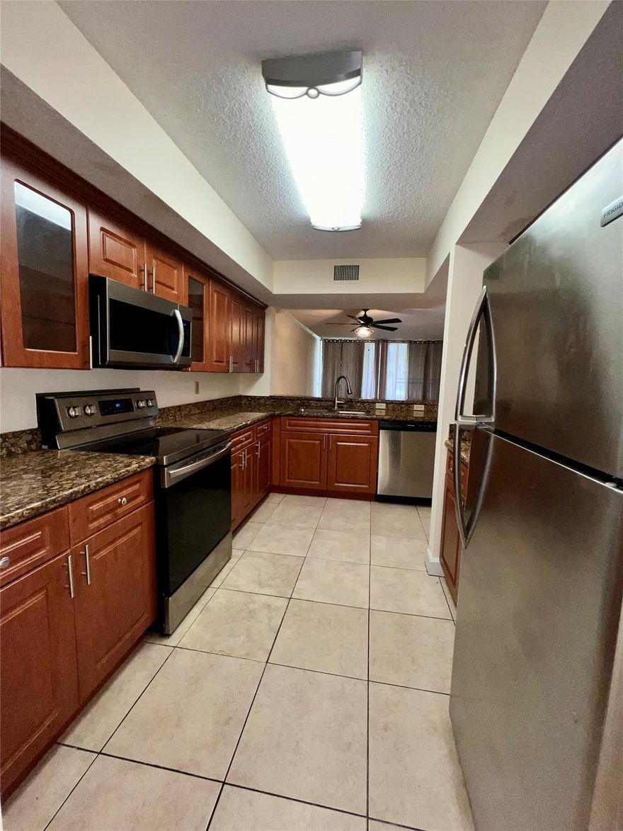 The perfect blend of comfort, convenience, and serene living in this beautifully maintained 2-bedroom, 2-bath first-floor condo in the heart of Coral Springs. Enjoy peaceful pool views and lush natural surroundings from your private patio, an ideal space for morning coffee or evening relaxation. Inside, you'll find a spacious layout featuring tile flooring throughout the main living areas and comfortable carpet in the bedrooms. The eat-in kitchen is equipped with stainless steel appliances, and an in-unit washer and dryer provide added everyday convenience. The A/C unit was recently updated in 2023, ensuring year-round comfort. Additional highlights include one assigned parking space with ample guest parking available.  Ideally located just minutes from parks, shopping, and dining.