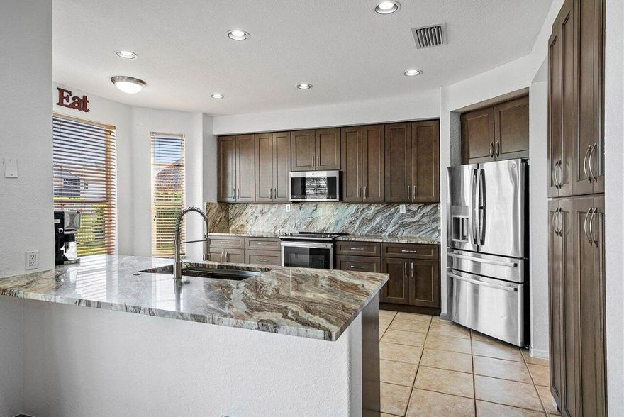 This impeccably Willow model offers 4 bedrooms plus a loft and 3 full baths, ideally positioned on a premium lakefront lot showcasing breathtaking long-lake views and unforgettable sunsets. Designed for both comfort and entertaining, the private outdoor retreat features a covered patio, pool, and fully fenced backyard, creating a true resort-style setting.
Inside, soaring vaulted ceilings, expansive windows, and abundant natural light highlight the home's open and spacious layout. The enhanced design provides an expansive family room, oversized bedrooms, and exceptionally generous closet space throughout.
The chef's kitchen is a complete with newer stainless-steel appliances, a double pantry, eat-in breakfast area, and ample cabinetry and counter space perfect for everyday living. The primary suite serves as a tranquil retreat, offering an optional office, nursery, or sitting area, double-door walk-in closet, and a spacious bath with peaceful lake views. Additional features include accordion hurricane shutters on second floor windows, a downstairs guest bedroom with full bath, and a two-car garage.
Located in Shadow Creek at Winston Trails, one of western Lake Worth's premier gated communities, residents enjoy a vibrant lifestyle paired with exceptional resort-style amenities. The Winston Trails community comprises 1,891 single-family homes and offers something for everyone, from recreation to relaxation.
Amenities include an Olympic-sized community pool, tennis and pickleball courts, two playgrounds, a driving range, and the Winston Trails public golf course. Residents also enjoy the convenience of a clubhouse with a restaurant and tiki bar, making it easy to gather, dine, and unwind close to home.