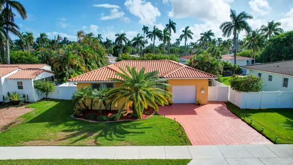 Spectacular remodeled pool home in much desired Hollywood Lakes. Sensational kitchen w. large island with storage, 6 burner gas stove, walk in pantry, decorative storage cabinets & numerous outlets. Bedrooms have custom closets w. 3 way doors in the primary bedroom & abundance of shelving & hanging room. Bathrooms are renovated. Florida room is fully enclosed w. windows making it a light and bright room for office & has its own mini-split air conditioner. French doors from the dining room onto the refinished patio area w. Travertine flooring, large pergola & built in speakers, inviting heated salt water pool and plenty of room for entertaining. This ''SMART home has a wall mount system for all tech boxes & wiring in the garage and ample storage .Updated electric & plumbing. IMPACT WINDOWS