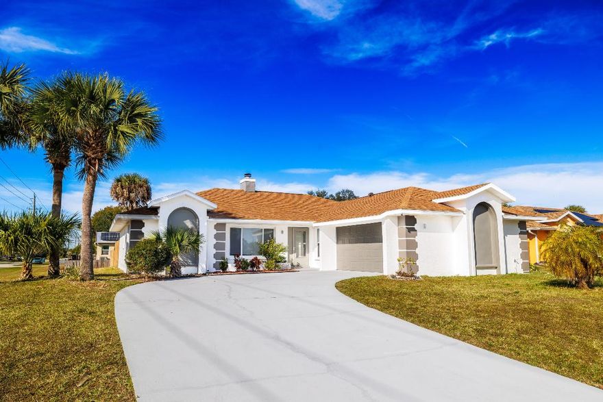 Welcome to this beautifully renovated Palm Bay home offering modern style, open living, and effortless Florida comfort. Set on a desirable corner lot, this light-filled residence features an open-concept layout anchored by a striking double-sided fireplace that serves as a true architectural focal point. Large-format marble-style tile flows throughout the main living areas, complemented by new wood-look flooring in the bedrooms. Major upgrades include a new roof (2025), new A/C unit (2025), and impact glass windows, providing peace of mind and energy efficiency. The updated kitchen showcases white shaker cabinetry, stone countertops, stainless steel appliances, and a generous peninsula ideal for casual dining or entertaining. The primary suite features an updated bathroom with a private sauna, creating a true at-home retreat. Outside, enjoy a wide driveway, two-car garage, mature palm trees, and a versatile yard with room for a pool or outdoor living. With modern finishes,

no HOA, and move-in-ready condition, this home is ideal for full-time living, seasonal use, or investment in a convenient Palm Bay location.