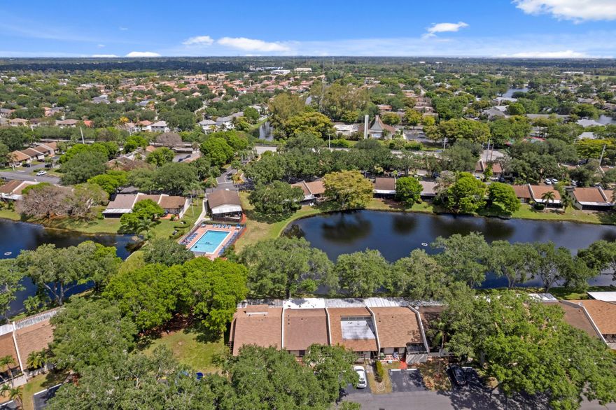 Enjoy serene lake views from this well-maintained 2BR/2BA single-story home in the quiet East Lakes community. Ideally situated near a wide range of amenities, this move-in-ready home features tile flooring throughout, vaulted ceilings, a brand-new A/C, and newer water heater. Spacious bedrooms include a primary suite with walk-in closet, plus full-size washer/dryer and ample storage. Step outside to over 400 square feet of covered and screened patio space - perfect for relaxing or entertaining while enjoying tranquil lake views. Accordion shutters provide added peace of mind. Includes 2 parking spaces, plenty of guest parking, low HOA, and pet-friendly community. Conveniently located near shopping, dining, and parks, this home offers comfort, convenience, and a wonderful lifestyle.