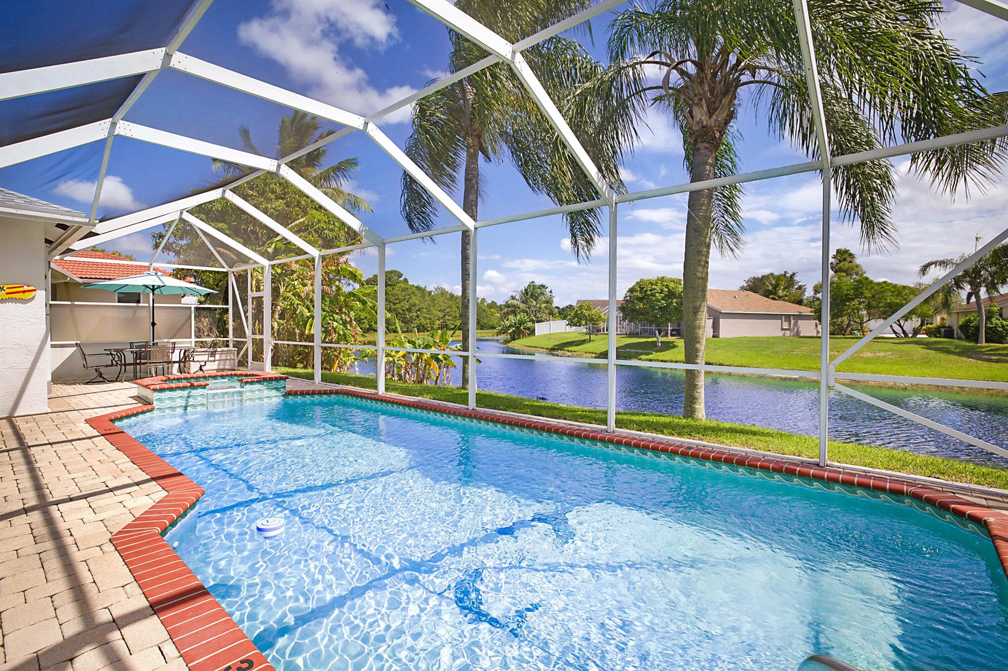Welcome to your dream home! This stunning 3-bedroom, 2-bathroom oasis on the water boasts one of most breathtaking waterfront views in all of florida. Unwind in the luxurious jacuzzi or make a splash in the oversized pool, perfect for gatherings! Located walking distance Okeeheelee Park, ideal for active families who love the outdoors! This isn't just a house; it's a home, a place where memories are made. Ready for immediate move-in, your new home awaits!