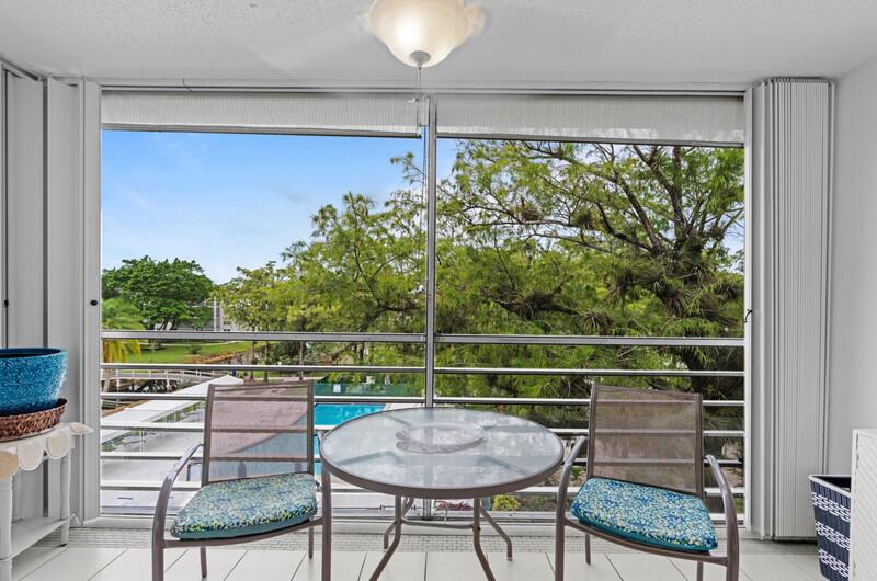 Discover this pristine, move-in ready 2/2 situated on the fourth floor of the highly desirable 55+ community of Cypress Chase -- offering peace of mind with no neighbors above and the most serene balcony view in the neighborhood. Gaze out over lush gardens, a sparkling pool, a peaceful canal, and a charming bridge from your private balcony, with sliding glass doors that fill the space with natural light.Inside, you'll find a spacious, bright layout featuring a generous dining and living area that is perfect for both relaxing and entertaining. The simple yet beautiful kitchen shines with white cabinetry, matching white appliances, a custom white backsplash, and rich, dark brown countertops that add a touch of warmth and sophistication. The master includes an en suite bathroom and...