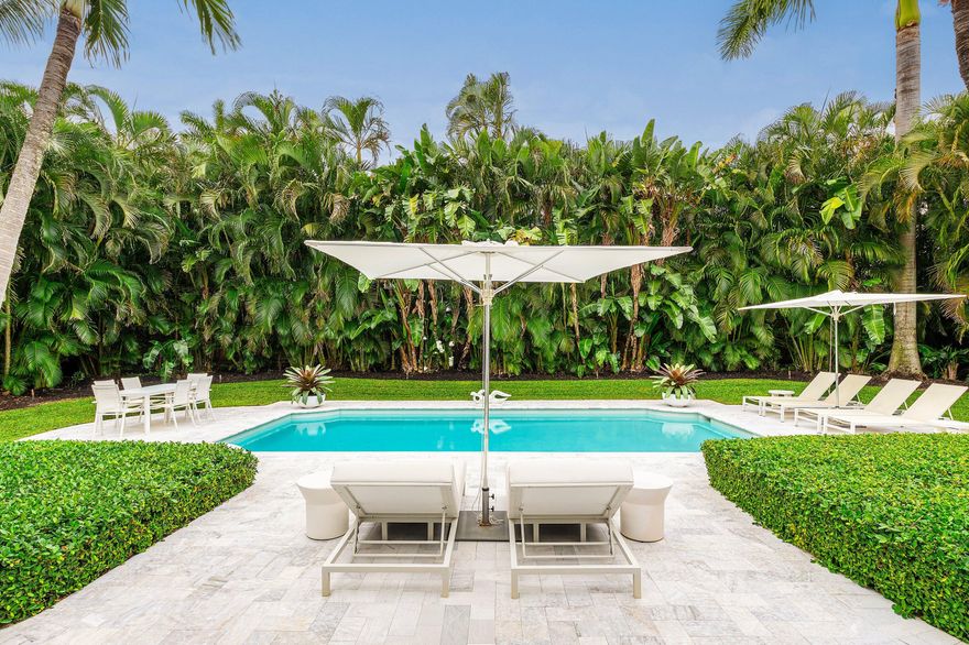 Live the South Florida dream on the barrier island of Hypoluxo Island—home to only 315 single-family residences and one of the best coastal values in all of South Florida. Perfectly positioned between Palm Beach and Delray Beach, this rare Mid-Century Modern estate is not just a home—it's a piece of art. Set on an oversized .36-acre double lot surrounded by lush tropical landscaping, this 3-bedroom, 2.5-bath single-story residence with a 2-car garage blends timeless architecture with thoughtful modern updates. The spacious living room with fireplace opens through a dramatic wall of glass to an oversized loggia with beamed ceilings, seamlessly connecting indoor and outdoor living. The private backyard retreat features a sparkling new pool, expansive deck, and beautifully redesigned  landscaping, creating a tranquil setting for entertaining or relaxing in total privacy. The open gourmet kitchen offers quality appliances and a gas range, ideal for everyday living or hosting guests.  The serene primary suite overlooks the gardens and features a newly renovated bath with luxurious soaking tub and separate shower. Recent upgrades include newer roof, impact doors and windows, electric floor-to-ceiling screens for cross-ventilation, a porcelain tile driveway, new pool, and refreshed landscaping.  Moments from the ocean and minutes from the world-class amenities of Eau Palm Beach Resort & Spa, this exceptional residence offers the rare opportunity to own a true architectural gem in one of Palm Beach County's most coveted island communities.