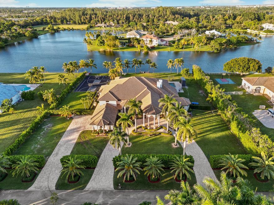 WELCOME TO THE EPITOME OF OPULENCE IN THE HIGHLY SOUGHT-AFTER EXOTIC ACRES, A SUPER-LUXURY COMMUNITY THAT DEFINES PRESTIGE. THIS ULTRA-LUXURIOUS CUSTOM HOME, BOASTING AN IMPRESSIVE 8 BEDROOMS AND 7.5 BATHROOMS, IS A MASTERPIECE OF DETAILED DESIGN. ENJOY THE BREATHTAKING VIEWS OF THE LAKE FROM EVERY ANGLE OF THIS FULLY REMODELED RESIDENCE. THE NEW KITCHEN, ADORNED WITH ULTRA-LUXURY FINISHES, SETS THE STAGE FOR CULINARY DELIGHTS. NEW EXQUISITE TILE FLOORS THROUGHOUT, EVERY INCH OF THIS HOME EXUDES SOPHISTICATION. 14 NEWLY INSTALLED CAMERA SYSTEM WITH A 3-CAR GARAGE ADDING TO THE CONVENIENCE, THIS PROPERTY REPRESENTS THE PINNACLE OF LUXURY LIVING—WHERE EVERY AMENITY AND EXQUISITE FEATURE HARMONIOUSLY CONVERGE TO CREATE A TRULY UNPARALLELED LIVING EXPERIENCE. ***NEW ROOF INSTALLED 2020***