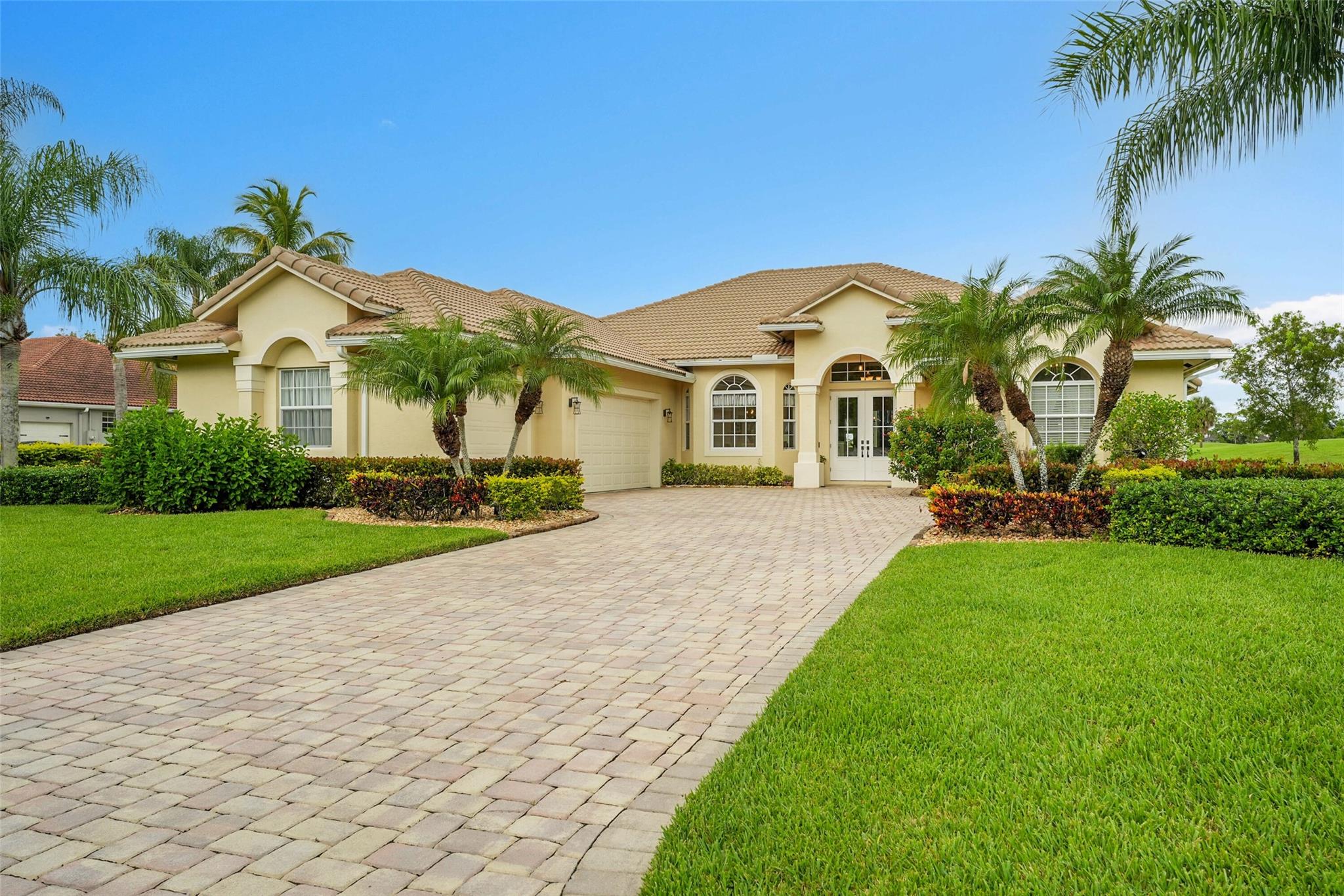 Stunning solid block construction home features a split floor plan with three bedrooms, two and a half baths with 3-car oversized garage complete with built-in workshop. From the moment you step inside, you'll be captivated by the openness. Cooking in your spacious island kitchen is a delight, featuring generous granite countertops and stylish cabinets with elegant crown molding. Two spacious living areas. Primary bedroom with soaking tub, walk-in closets, chandelier that adds a touch of luxury. The home features tile flooring throughout, with cozy carpet in the guest bedrooms. Impact-resistant windows and water filtration system. This stunning property comes fully furnished and is located on the 1st fairway, incredible views of the golf course, pond, and pool just steps from your door.