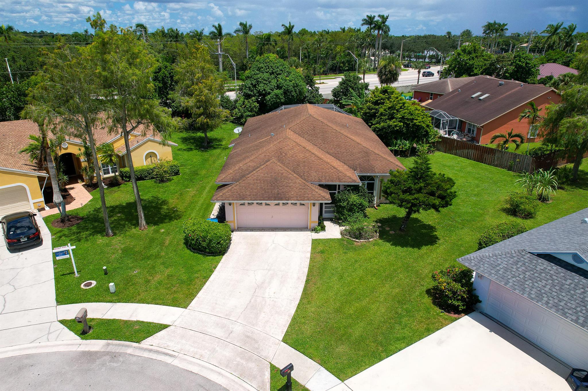 This spacious and beautifully maintained home is ready to welcome you. Enjoy Florida living in your private backyard oasis, featuring a screened lanai with pool and spa, plus a covered patio with dual access from both the primary bedroom and family room. The inviting living room, with volume ceilings, is perfect for holiday gatherings or relaxed evenings with guests, while the expansive family and dining areas offer ample space for entertaining. The kitchen seamlessly flows into the main living areas, ensuring everyone stays connected. Tile and LVP flooring run throughout for style and easy maintenance. Two guest bedrooms share a full bath, and the primary suite offers a spa-like retreat with a separate shower and soaking tub.