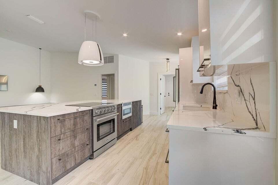 Unique & truly one of a kind, like no other home offered in Riverwalk before, this home features unsurpassed quality & renovations w/meticulous attention to detail. Diligently completed w/all required permits, a no expense spared renovation including a brand new roof, hurricane impact windows & doors, state of the art appliances, all new fixtures, brand new a.c. system, built in closets,upgraded electrical that is ready to support two EV fast chargers, brand new flooring throughout, travertine pavers on the patio & so much more. Riverwalk offers 3 heated swimming pools, a fitness center,pickleball & tennis courts, a restaurant, hair salon,post office,walking paths & lush landscaping throughout the community.This is a one of a kind home that is not to be missed!Fall in love with Riverwalk.