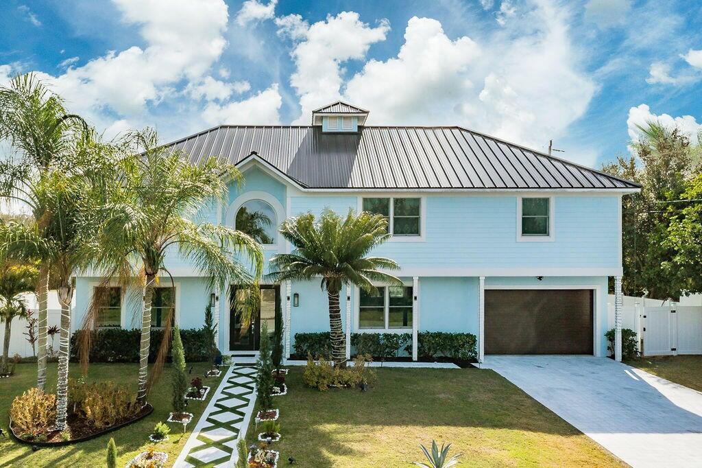 Spectacular, 2 story home is a  masterpiece of design & functionality,  situated on a prime corner lot. The home boasts 5 bedrooms and 4 bathrooms, 10-ft ceilings w/ new Anderson impact windows/doors. Chef's dream, Viking appliances. Porcelain tiles throughout.The grand primary suite is a private retreat, tremendous walk-in, spa-like en suite bathroom provides a luxurious escape. The backyard features a new, heated in-ground pool, captivating infinity-edge jacuzzi,  and cabana bath. Generator hookup, a tankless water heater, and propane hookups for both the gas range and an outdoor grill. .Minutes to gourmet restaurants , golf and beaches.